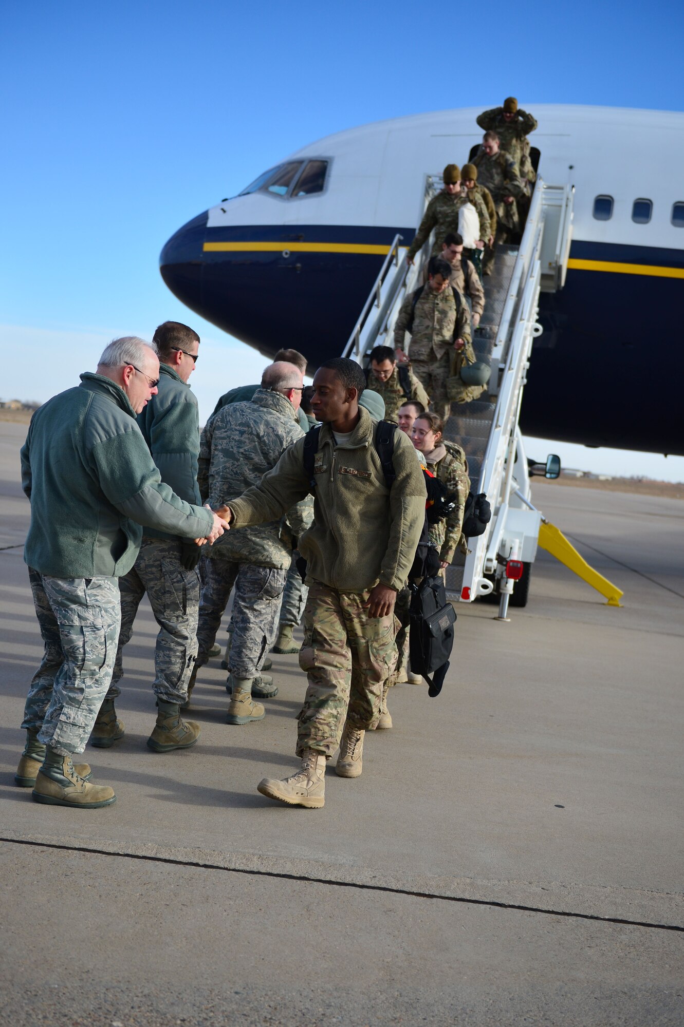 Air Commandos returning from deployment, are greeted by 27th Special Operations Wing leadership upon departing an aircraft during Operation Homecoming at Cannon Air Force Base, N.M., Dec. 9, 2012. Operation Homecoming is a monthly event held to welcome Air Commandos back from worldwide deployments and reunite them with their loved ones. (U.S. Air Force photo/Airman 1st Class Eboni Reece)