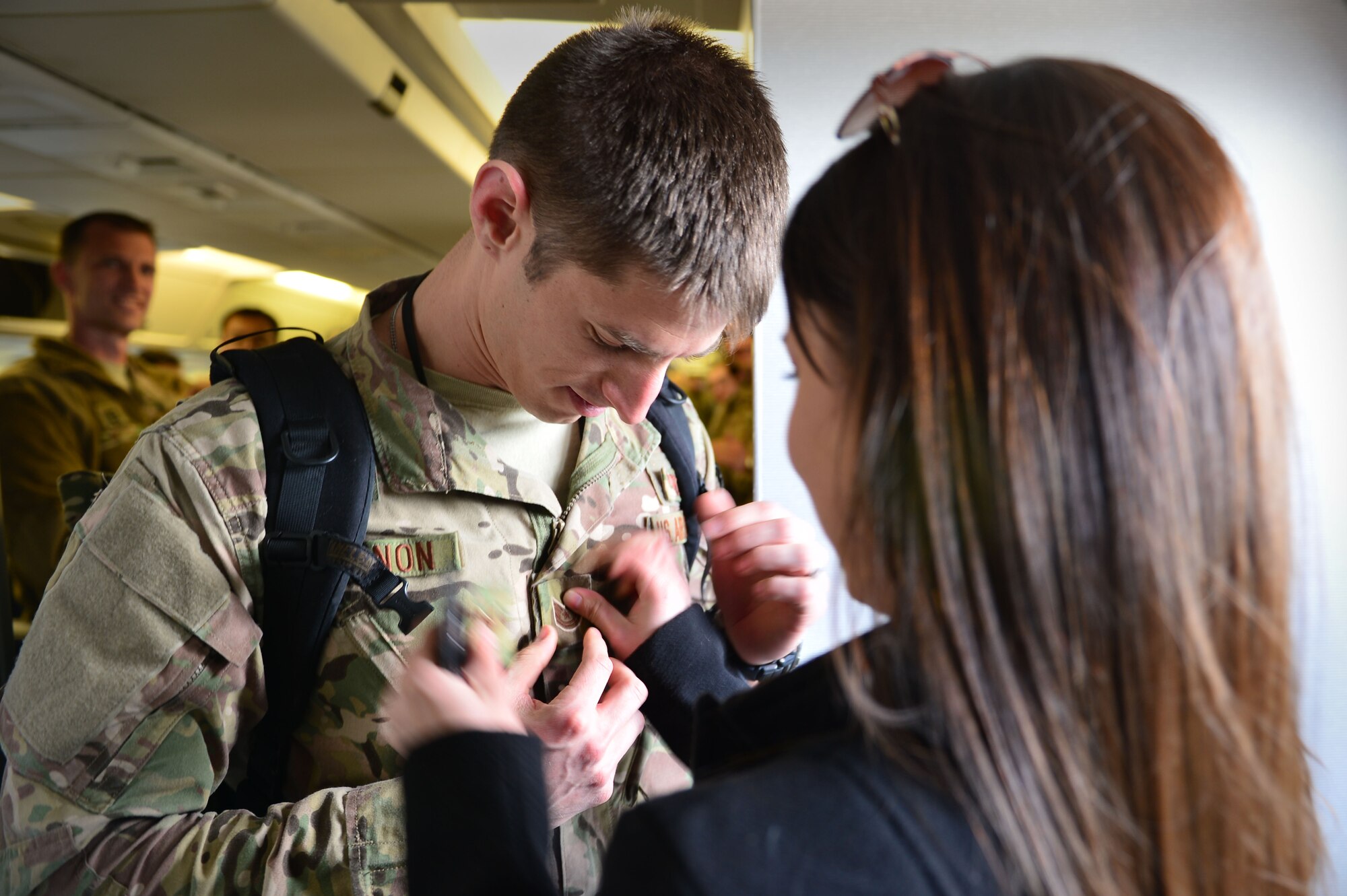 U.S. Staff Sgt. Robert O'Bannon, 16th Special Operations Squadron, recieves a new rank insignia from his wife after being presented with a Stripes for Exceptional Performers promotion at Cannon Air Force Base, N.M., Dec. 9, 2012. O'Bannon was promoted due to his consistent record of exceptional performance and service. (U.S. Air Force photo/Airman 1st Class Eboni Reece)