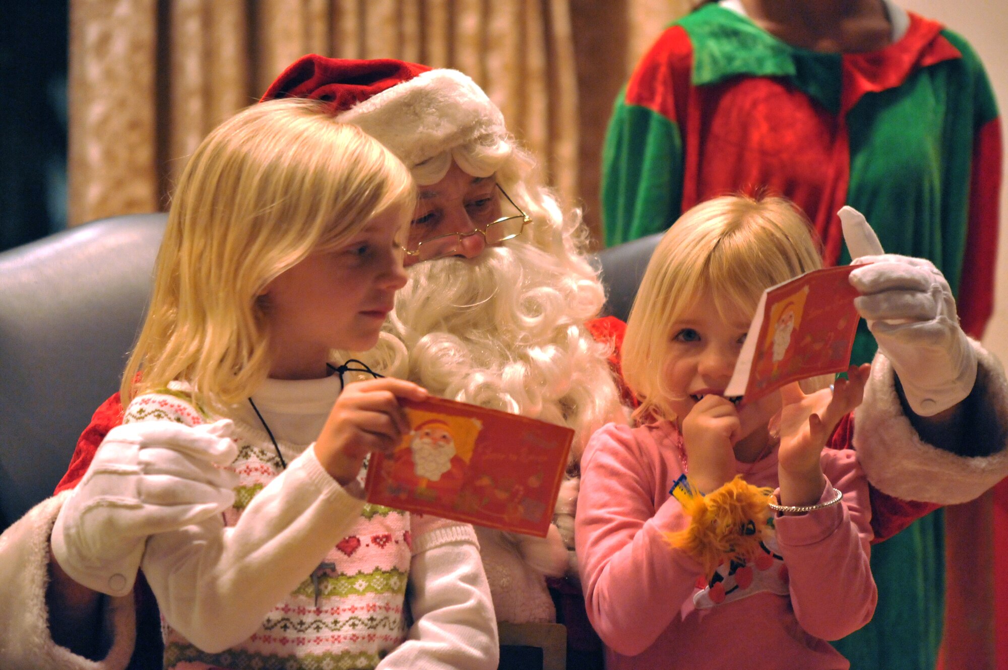 Two girls tell Santa what they want for Christmas during the annual tree lighting at Fort MacArthur, Nov. 30. (Photo by Sarah Corrice)