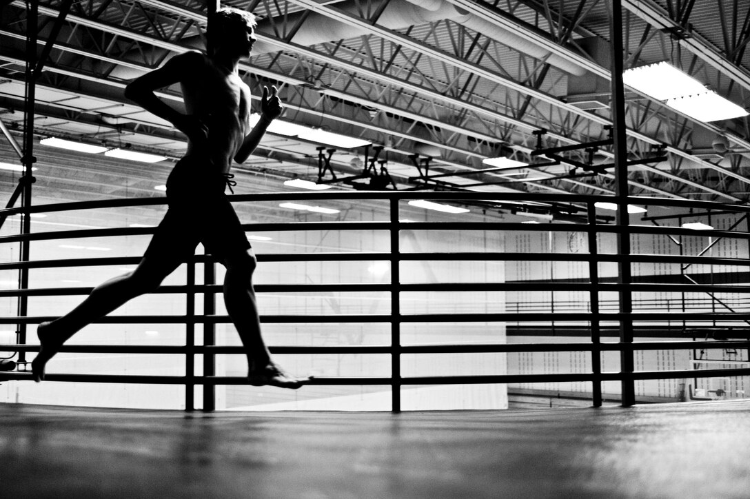 Brandon Zelfer runs his final lap during the Bellamy Fitness Center’s Indoor Triathlon at Ellsworth Air Force Base, S.D., March 24, 2012. The triathlon consisted of a 300 yard swim, a 30 minute ride on the stationary bike and a 1.5 mile run. (U.S. Air Force photo by Airman 1st Class Anania Tekurio/Released)