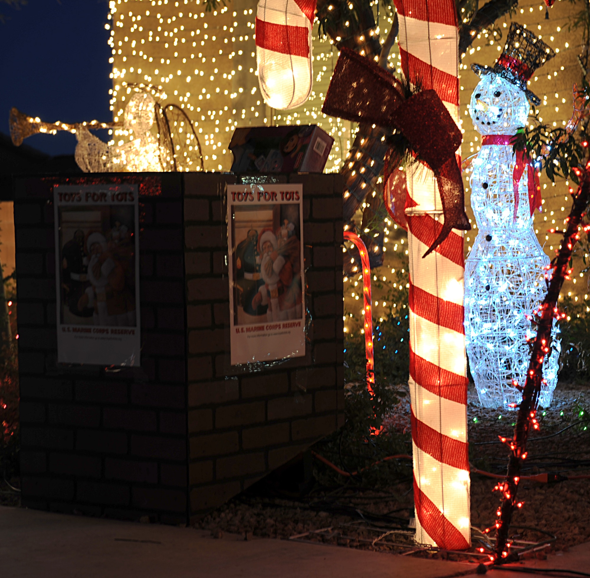 Christmas decorations surround a drop off box for the Marine Toys for Tots Foundation at the house of U.S. Air Force 1st Lt. Joshua Palochak, 41st Electronic Combat Squadron, in Tucson, Ariz., Dec. 1, 2012. Palochak programmed the decorations on his house to "dance" to a local radio station to encourage more donations. (U.S. Air Force photo by Senior Airman Timothy Moore/Released)