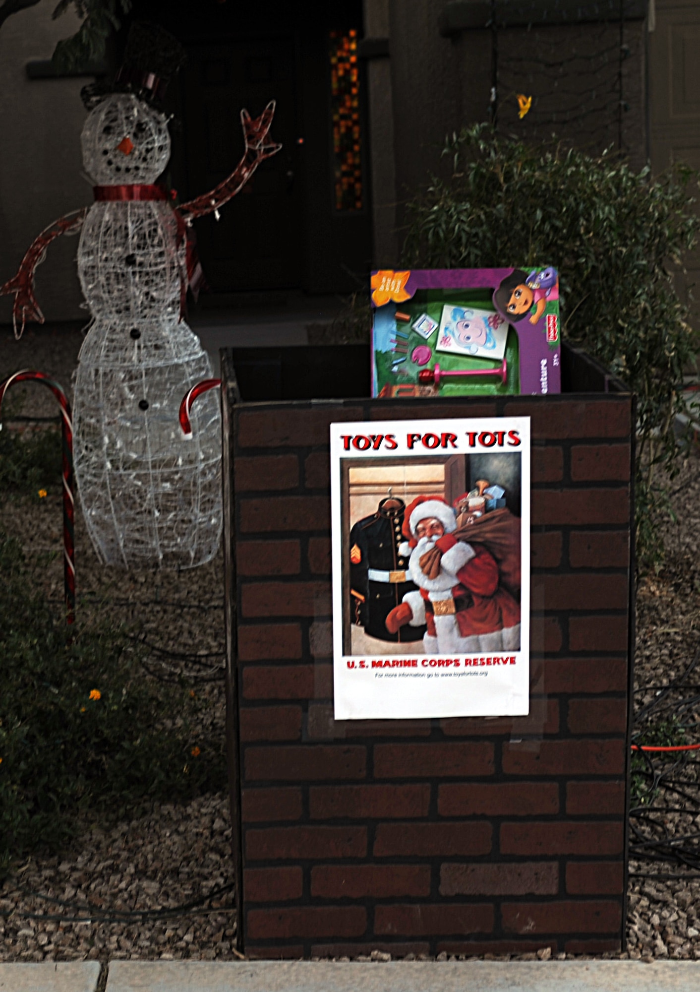 A designated toy donation box sits outside the house of U.S. Air Force 1st Lt. Joshua Palochak, 41st Electronic Combat Squadron, in Tucson, Ariz., Dec. 1, 2012. Palochak used his "dancing" Christmas lights to encourage people to donate toys to the Marine Toys for Tots Foundation. (U.S. Air Force photo by Senior Airman Timothy Moore/Released)