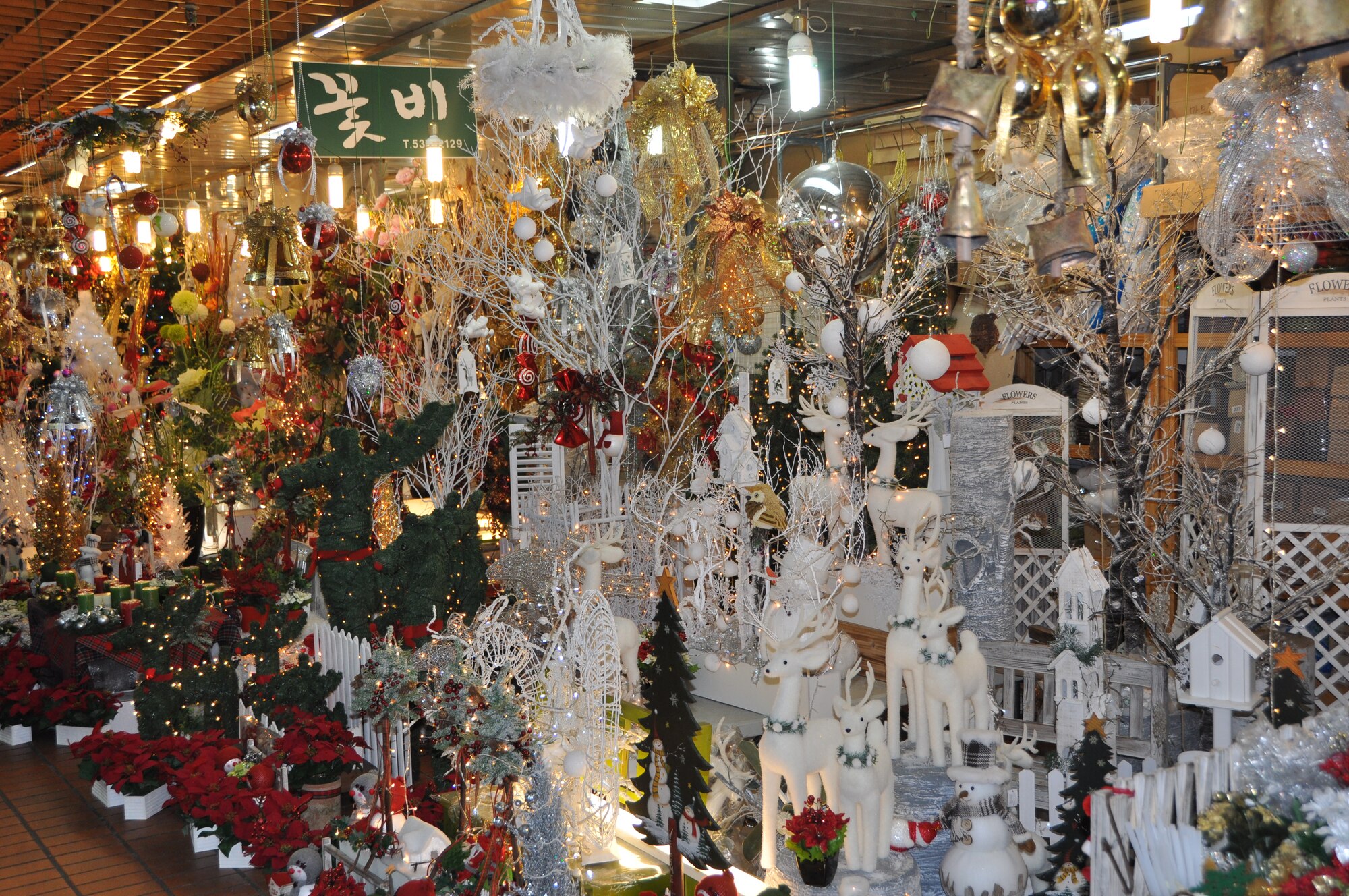 The Holiday Shop, Flower Market features the decorations needed to add for Christmas cheer. The selection includes affordable Christmas trees in different sizes, as well as wreaths, ribbons, snowmen, candles, bells, ornaments, lights and more. (U.S. Air Force photo/Senior Airman Kristina Overton)