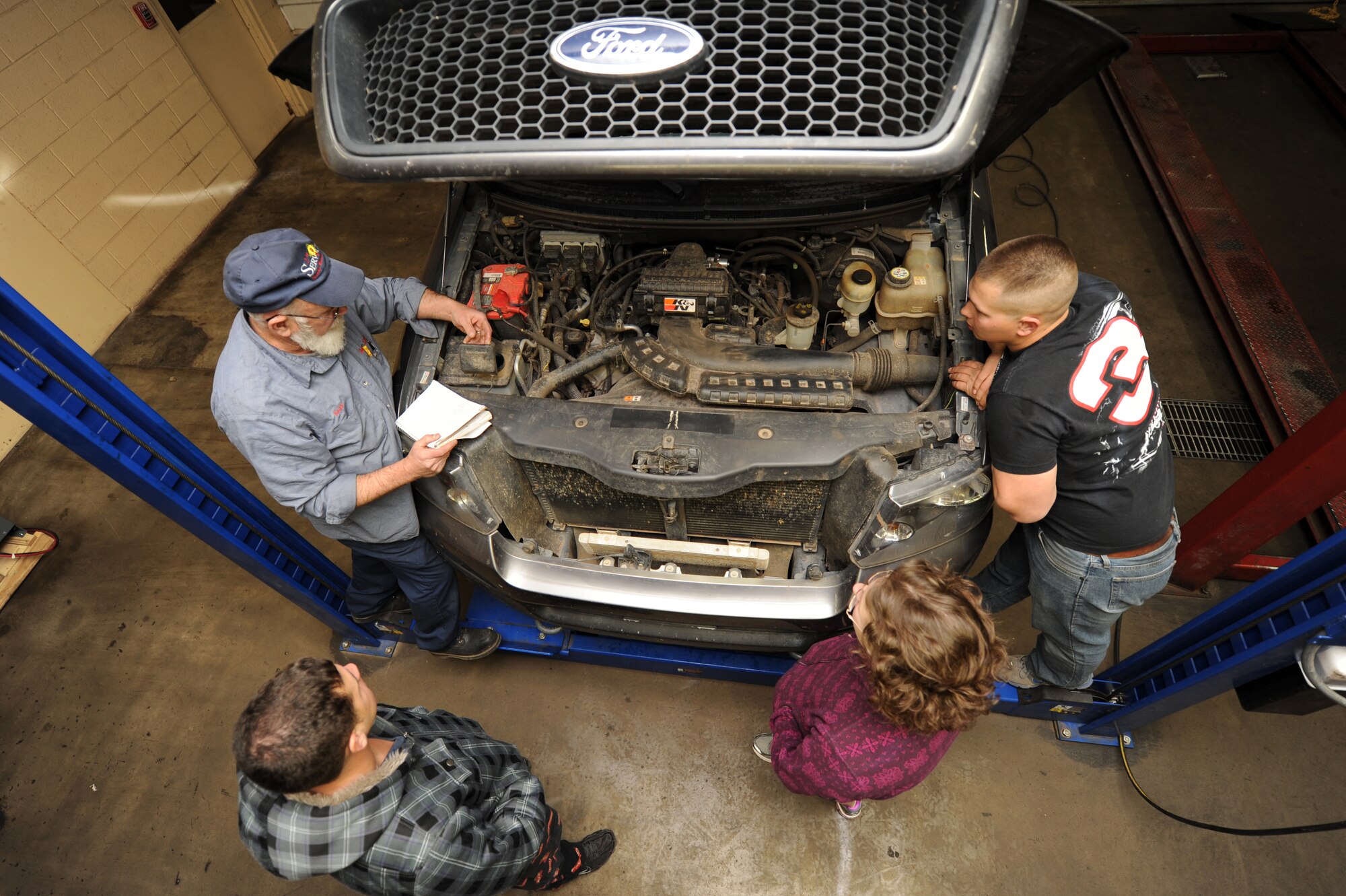 Keith Robertson, 27th Special Operations Force Support Squadron skills development manager, teaches a free class on oil change procedures at Cannon Air Force Base, N.M., Dec. 6, 2012.  The Auto Skills Center has recently begun monthly automotive care classes to better educate Airmen who would like to do their own vehicle maintenance.  (U.S. Air Force photo/Senior Airman Jette Carr)