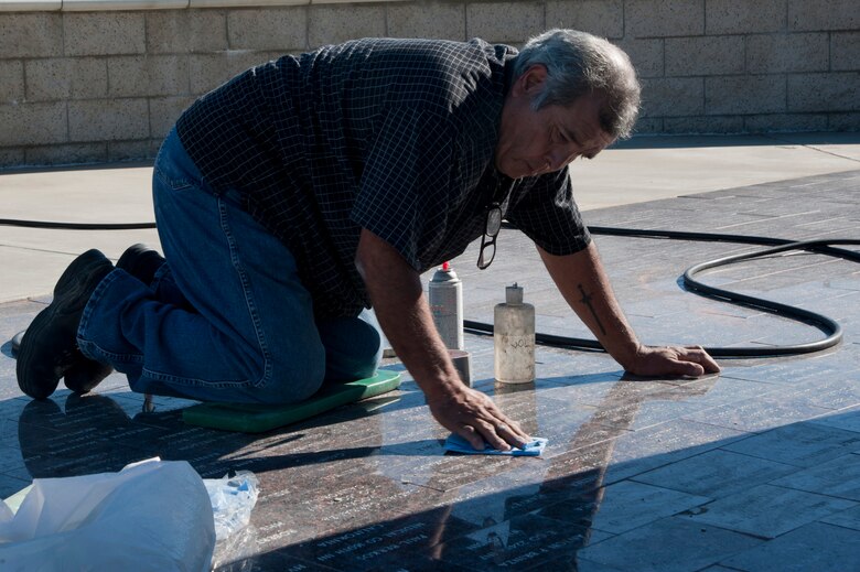 VANDENBERG AIR FORCE BASE, Calif. –Augie Ortiz, Santa Barbara Monumental Company certified memorialist, wipes the residue from the new names on marble bricks at the 40th Infantry Division Korean War Memorial here Monday, Dec. 10, 2012. The 40th lost nearly 400 soldiers in a year during the Korean War. To honor the fallen, names are etched into bricks at the memorial yearly. (U.S. Air Force photo/Senior Airman Lael Huss)