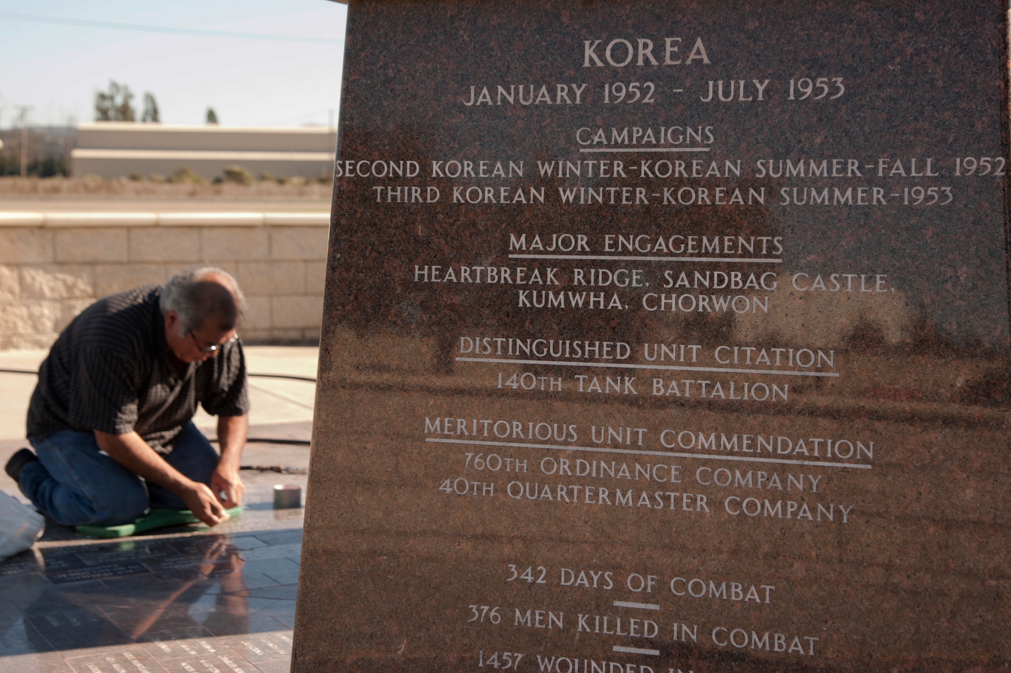 VANDENBERG AIR FORCE BASE, Calif. –Augie Ortiz, Santa Barbara Monumental Company certified memorialist, cleans the marble bricks at the 40th Infantry Division Korean War Memorial here Monday, Dec. 10, 2012. The 40th lost nearly 400 soldiers in a year during the Korean War. To honor the fallen, names are etched into bricks at the memorial yearly. (U.S. Air Force photo/Senior Airman Lael Huss)