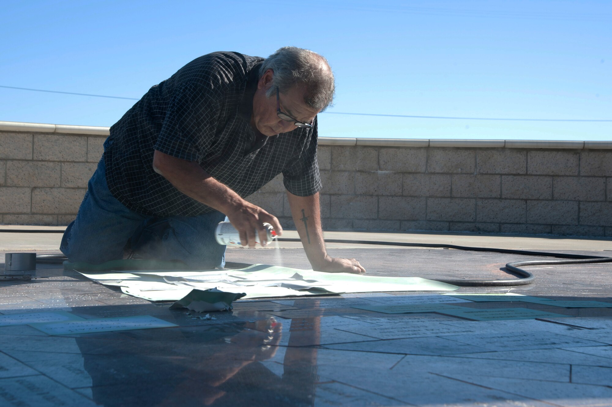 VANDENBERG AIR FORCE BASE, Calif. –Augie Ortiz, Santa Barbara Monumental Company certified memorialist, shellacks names into marble bricks at the 40th Infantry Division Korean War Memorial here Monday, Dec. 10, 2012. The 40th lost nearly 400 soldiers in a year during the Korean War. To honor the fallen, names are etched into bricks at the memorial yearly. (U.S. Air Force photo/Senior Airman Lael Huss)