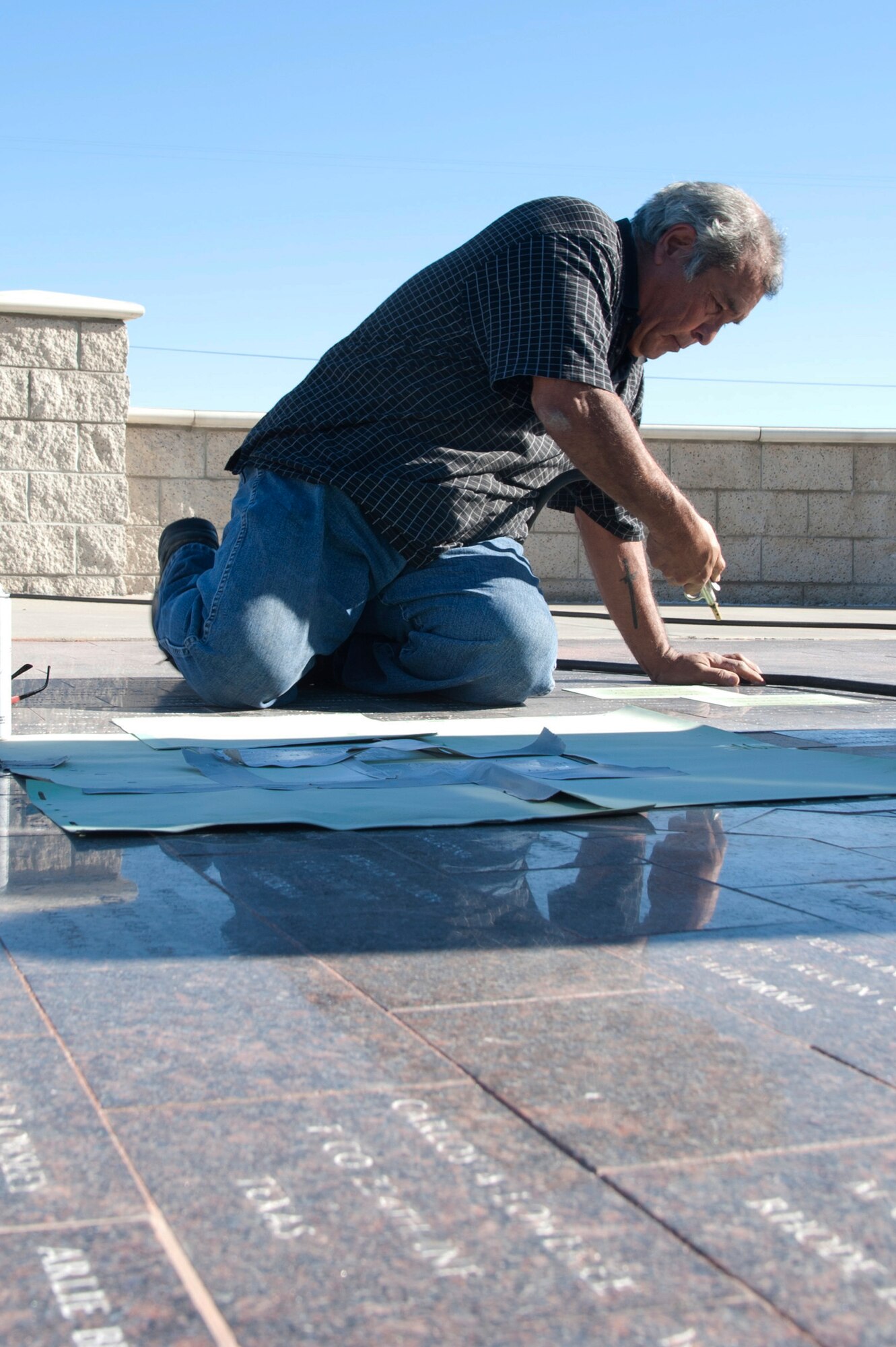 VANDENBERG AIR FORCE BASE, Calif. –Augie Ortiz, Santa Barbara Monumental Company certified memorialist, sandblasts names into marble bricks at the 40th Infantry Division Korean War Memorial here Monday, Dec. 10, 2012. The 40th lost nearly 400 soldiers in a year during the Korean War. To honor the fallen, names are etched into bricks at the memorial yearly. (U.S. Air Force photo/Senior Airman Lael Huss)