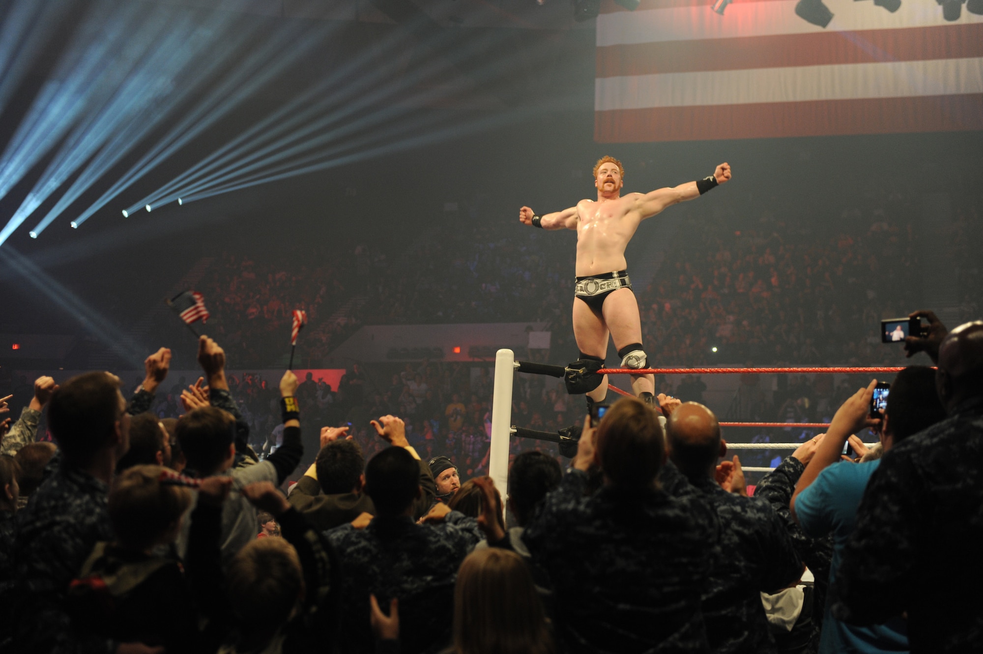 Service members celebrate as World Wrestling Entertainment Superstar, Sheamus, raises his arms in victory after a match during a live show at the Norfolk Scope Arena, Norfolk, Va., Dec. 9, 2012. The show was part of the 10th annual WWE "Tribute to the Troops" week honoring active duty members of the U.S. Armed Forces. (U.S. Navy photo by Mass Communication Specialist 1st Class Molly A. Burgess/Released)