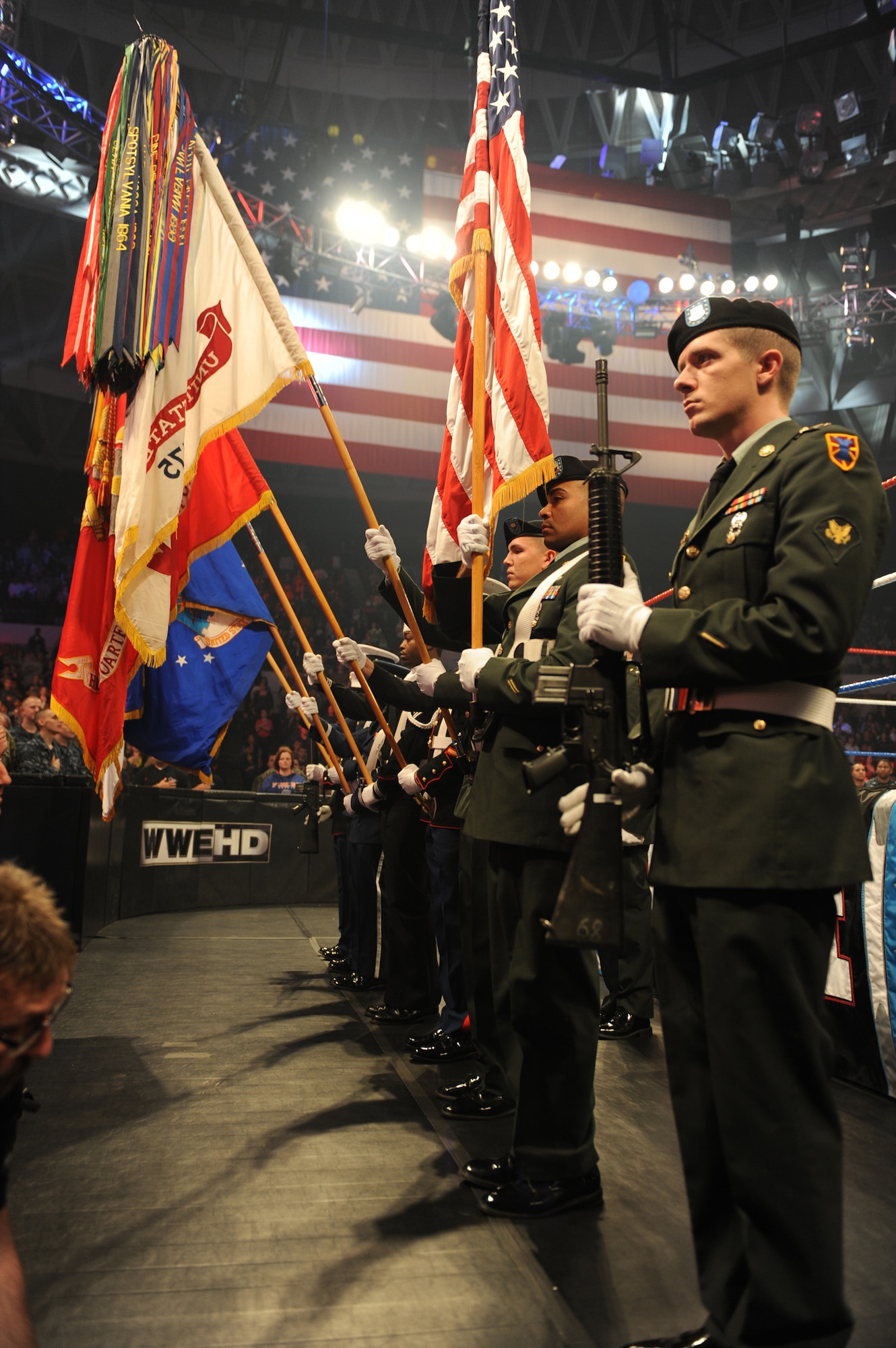 The Joint Sevice Color Guard parades the colors throughout the playing of the national anthem, during a live World Wrestling Entertainment show at the Norfolk Scope Arena, Norfolk, Va., Dec. 9, 2012. The show was part of the 10th annual WWE "Tribute to the Troops" week in honor of active duty Service members. (U.S. Navy photo by Mass Communication Specialist 1st Class Molly A. Burgess/Released)