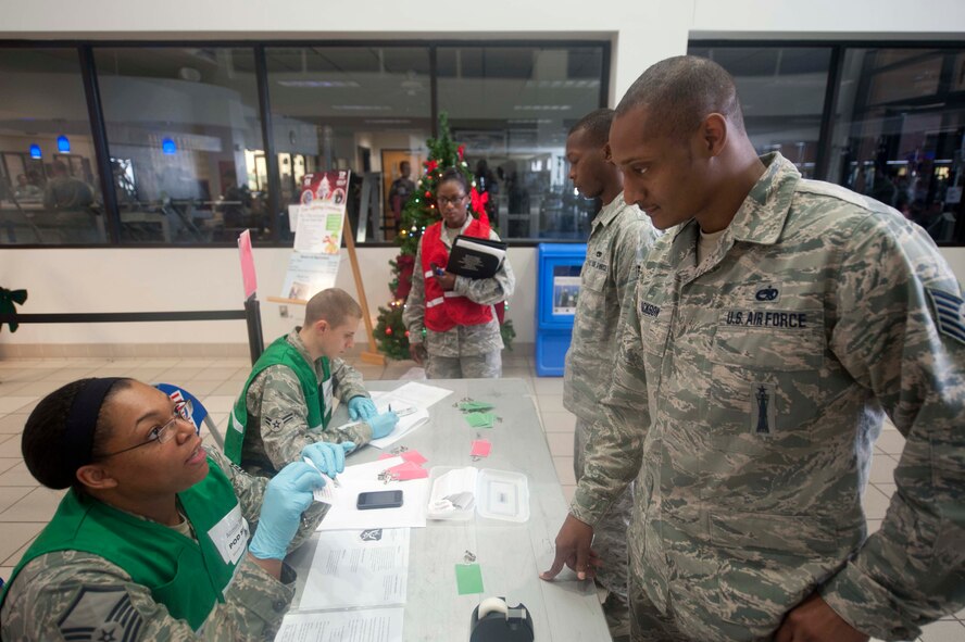 U.S. Air Force Tech. Sgt. Robert Jackson, a weapons technician currently assigned to the 23d Wing Safety Office, fills out paperwork during a disease containment exercise at Moody Air Force Base, Ga., Dec.  7, 2012. The 23d Medical Group tested their ability to process thousands of individuals in a short amount of time in case of an Influenza-like epidemic. (U.S. Air Force photo by Airman Paul Francis/Released)
