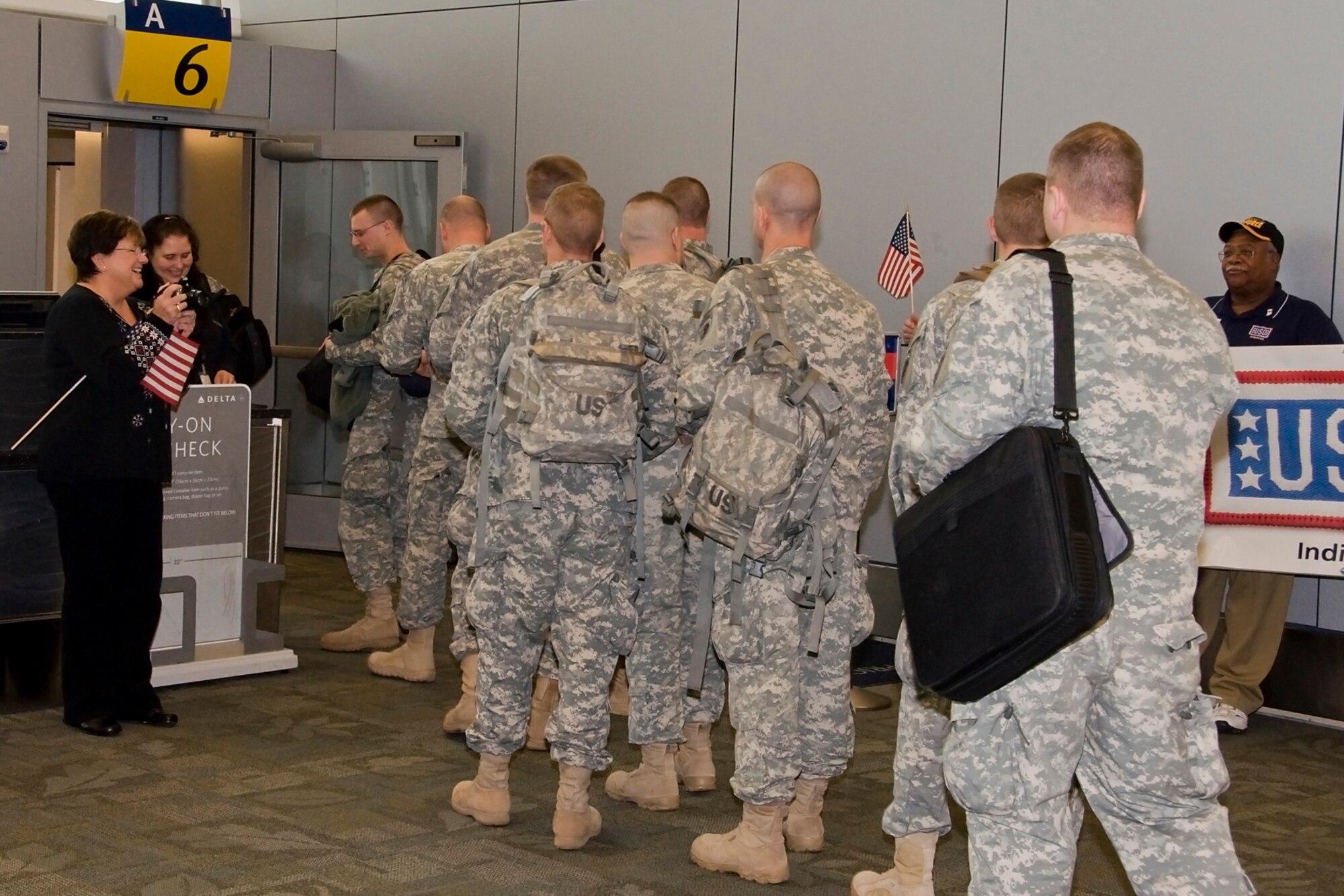 GRISSOM AIR RESERVE BASE, Ind. -- Soldiers from the 316th Psychological Operations Company out of Grissom board an aircraft at Indianapolis International Airport Dec. 7 shortly after a departure ceremony was held to honor their service. The Soldiers will be supporting Operation Enduring and are expected to be gone for 10 months. (U.S. Air Force photo/Staff Sgt. Ben Mota)