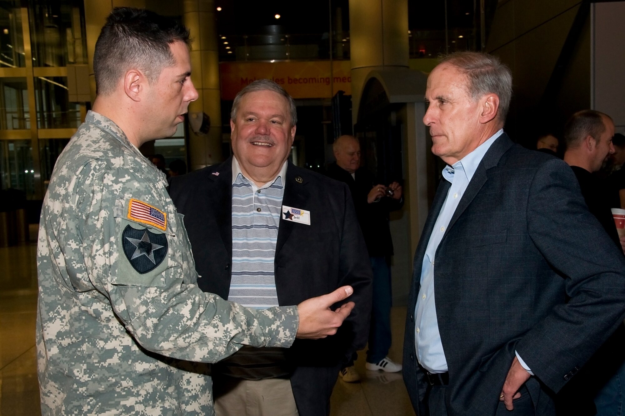 GRISSOM AIR RESERVE BASE, Ind. -- Maj. Glenn Baugh, 316th Psychological Operations Company tactical detachment officer in charge, speaks with Sen. Dan Coats about a deployment shortly after a departure ceremony held at Indianapolis International Airport Dec. 7 for 24 soldiers preparing to leave for Africa. The Soldiers will be supporting Operation Enduring Freedom and are expected to be gone for 10 months. (U.S. Air Force photo/Staff Sgt. Ben Mota)