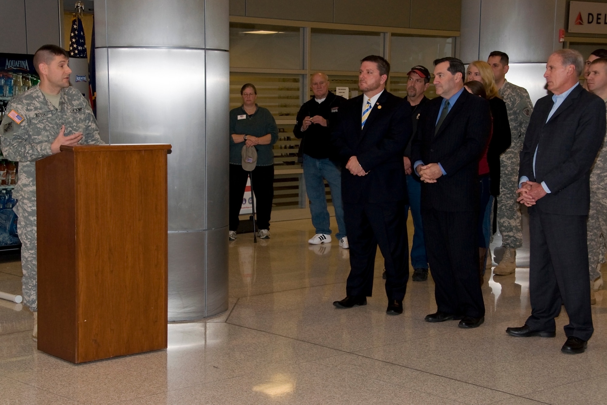 GRISSOM AIR RESERVE BASE, Ind. ? Lt. Col John Novak, 16th Psychological Operations Battalion commander, speaks to (left to right), Indiana State Rep. Kevin Mahan, Sen.-elect Joe Donnelly, Sen. Dan Coats and other attendees during a deployment ceremony at Indianapolis International Airport Dec. 7. The Soldiers will be supporting Operation Enduring and are expected to be gone for 10 months. (U.S. Air Force photo/Staff Sgt. Ben Mota)