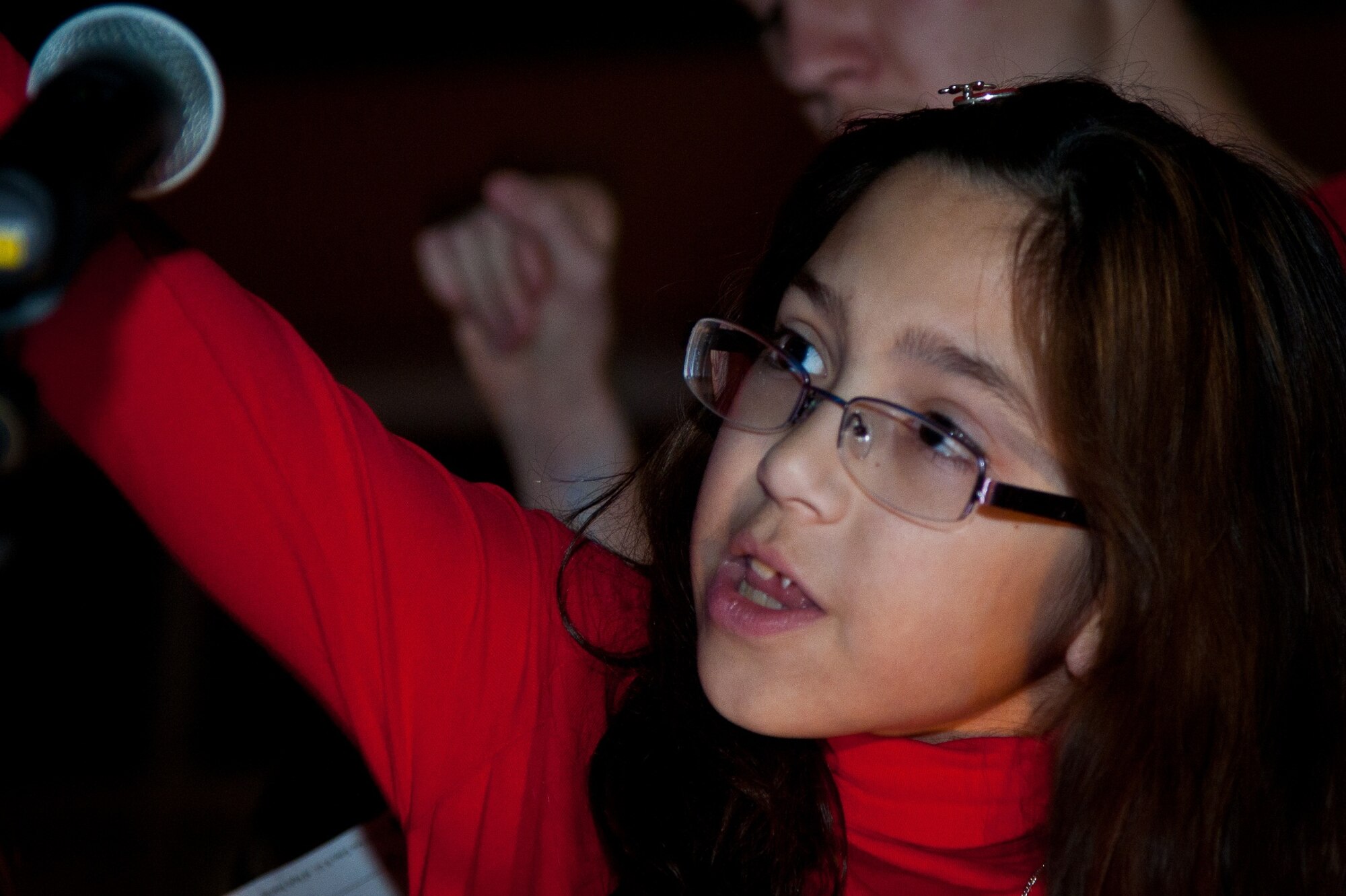 Bottom left, Rachel Del Prado, 10, daughter of Chap. (Capt.) David and Librada Del Prado, sings with the Maxwell Chapel Protestant children's choir during the tree lighting festivities Monday at Maxwell. (U.S. Air Force photo by Donna Burnett)