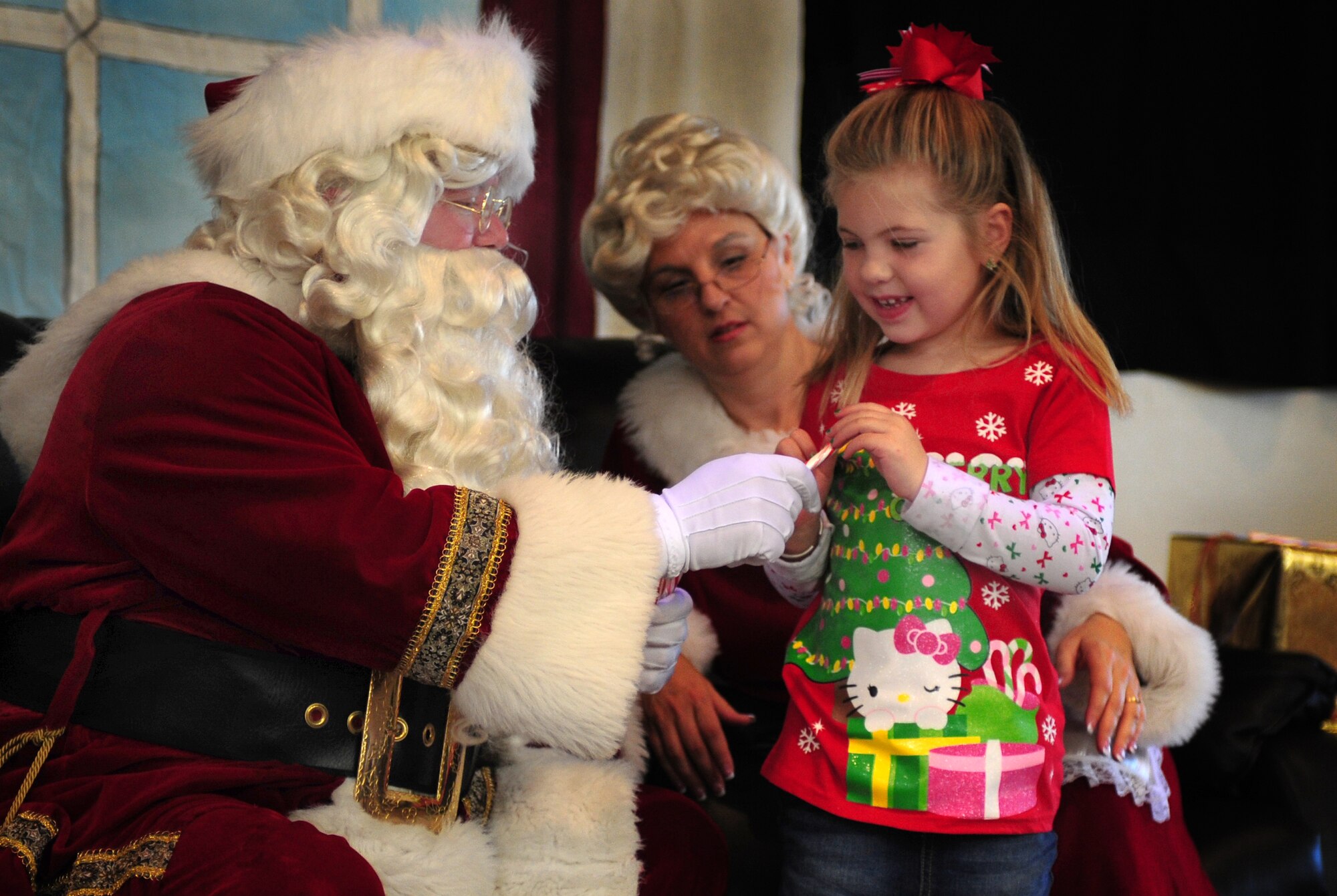 A child receives a candy cane from St. Nick during Breakfast with Santa at Cannon Air Force Base, N.M.,  Dec. 8, 2012. The event was held at the Drop Zone and included breakfast, craft projects and a chance for the children to give Santa their Christmas wish lists. (U.S. Air Force photo/Airman 1st Class Ericka Engblom)