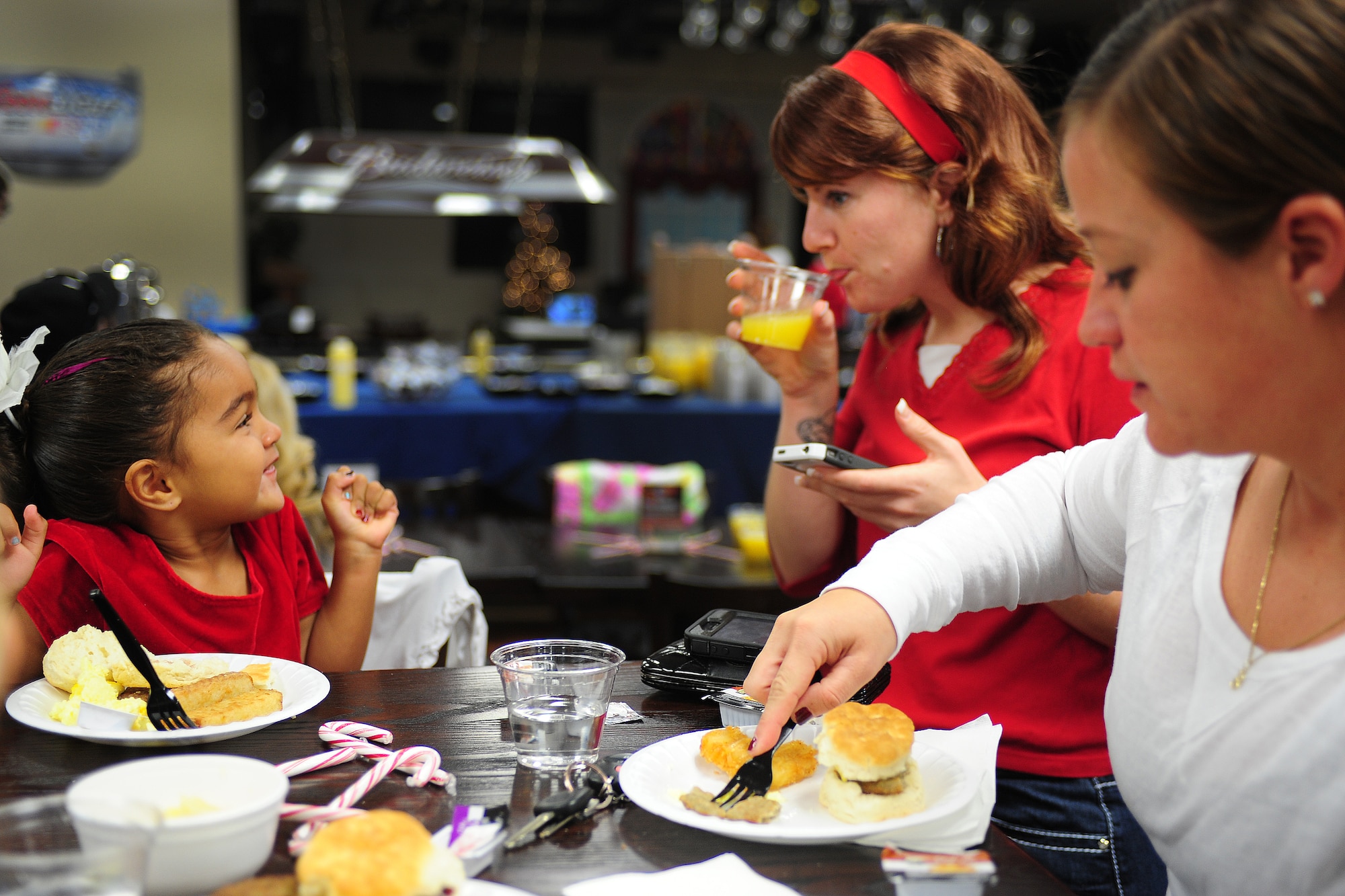 A family enjoys a meal together during Breakfast with Santa at Cannon Air Force Base, N.M.,  Dec. 8, 2012. The event was held at the Drop Zone and included breakfast, craft projects and a chance for the children to give Santa their Christmas wish lists. (U.S. Air Force photo/Airman 1st Class Ericka Engblom)