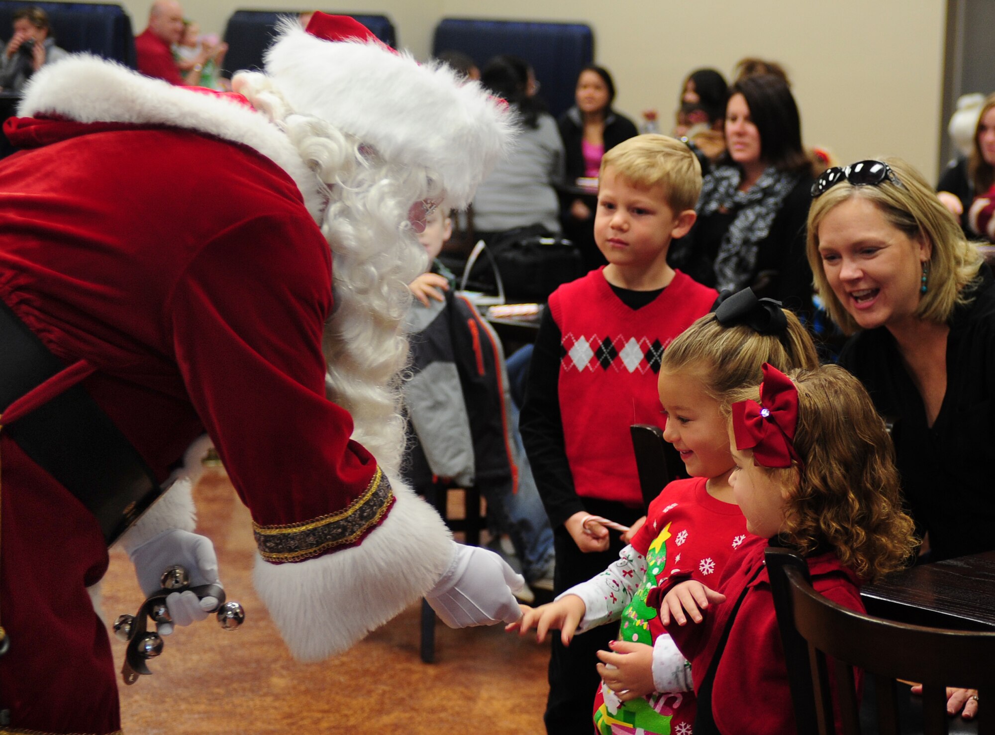 Children are greeted by Kris Kringal during Breakfast with Santa at Cannon Air Force Base, N.M., Dec. 8, 2012. The event was held at the Drop Zone and included breakfast, craft projects and a chance for the children to give Santa their Christmas wish lists. (U.S. Air Force photo/Airman 1st Class Ericka Engblom)