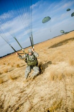 A U.S. paratrooper lands on Sicily Drop Zone for the 15th Annual Randy Oler Memorial Operation Toy Drop, hosted by a U.S Army Reserve unit, The U.S. Army Civil Affairs & Psychological Operations Command (Airborne), Dec. 8, 2012, at Fort Bragg, N.C. Operation Toy Drop is the world's largest combined airborne operation and allows soldiers the opportunity to help less fortunate children everywhere receive toys for the holidays. (U.S. Army photo/Staff Sgt. Osvaldo Equite)