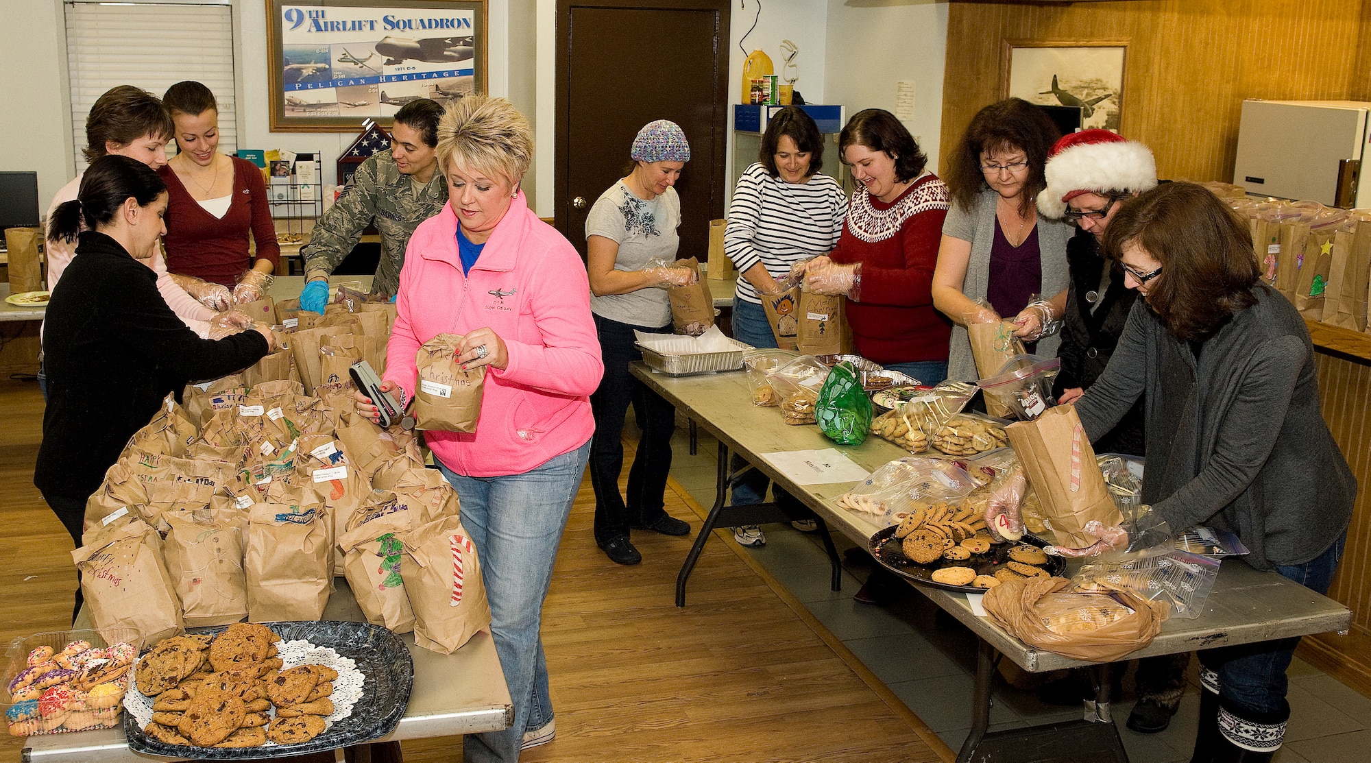 Operation Cookie Drop volunteers fill bags with donated cookies Dec. 10, 2012, at Dover Air Force Base, Del. Operation Cookie Drop is an annual event hosted by Dover AFB's Chief Group. The cookies will be delivered to Team Dover Airmen living in the dormitories. (U.S. Air Force photo/Roland Balik)