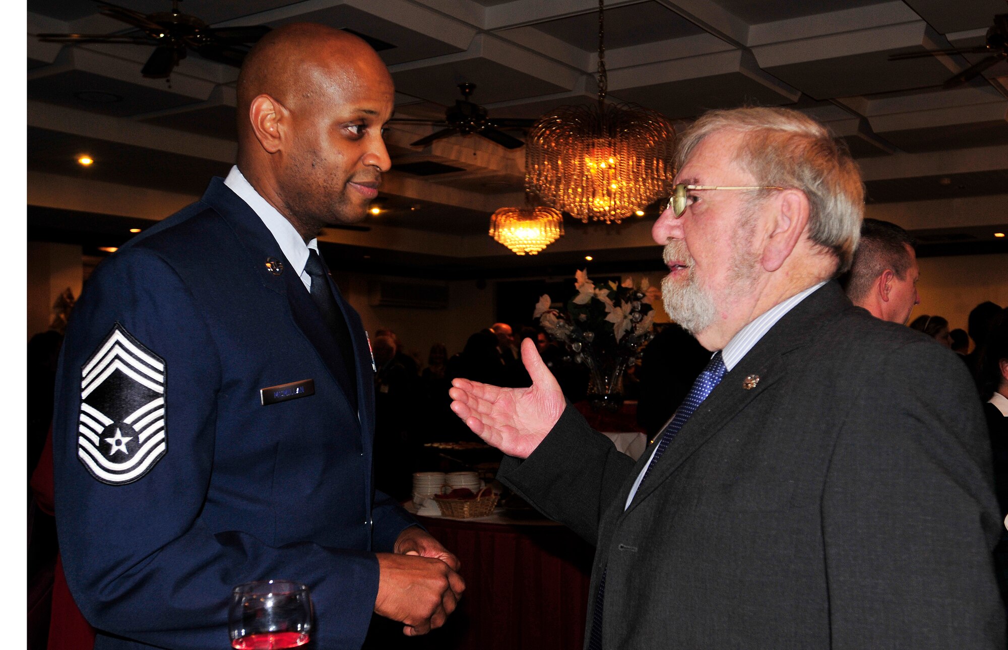 ROYAL AIR FORCE LAKENHEATH, England - Chief Master Sgt. Michael McMillan, 48th Mission Support Group superintendent, speaks with Michael Andrews, 48th Inpatient Care Squadron honorary commander, during the RAFs Lakenheath and Mildenhall's 2012 Yuletide Reception at Eagle's Landing Dec. 7, 2012.  Leadership from both bases welcomed community leaders to the event to celebrate the holiday season. (U.S. Air Force photo by Senior Airman Tiffany M. Grigg) 