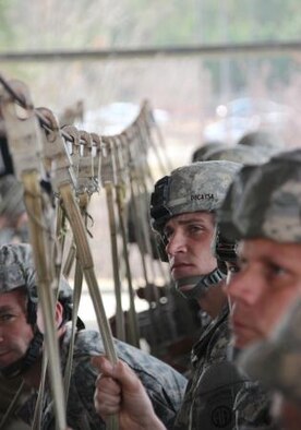Paratroopers listen to instructions as they go through sustained airborne training during the 15th Annual Randy Oler Memorial Operation Toy Drop, hosted by a U.S. Army Reserve unit, The U.S. Army Civil Affairs & Psychological Operations Command (Airborne), Dec. 7, 2012, at Pope Field, N.C. Operation Toy Drop is the world’s largest combined airborne operation and allows soldiers the opportunity to help less fortunate children everywhere receive toys for the holidays. (U.S. Army photo/Staff Sgt. Sharilyn Wells)