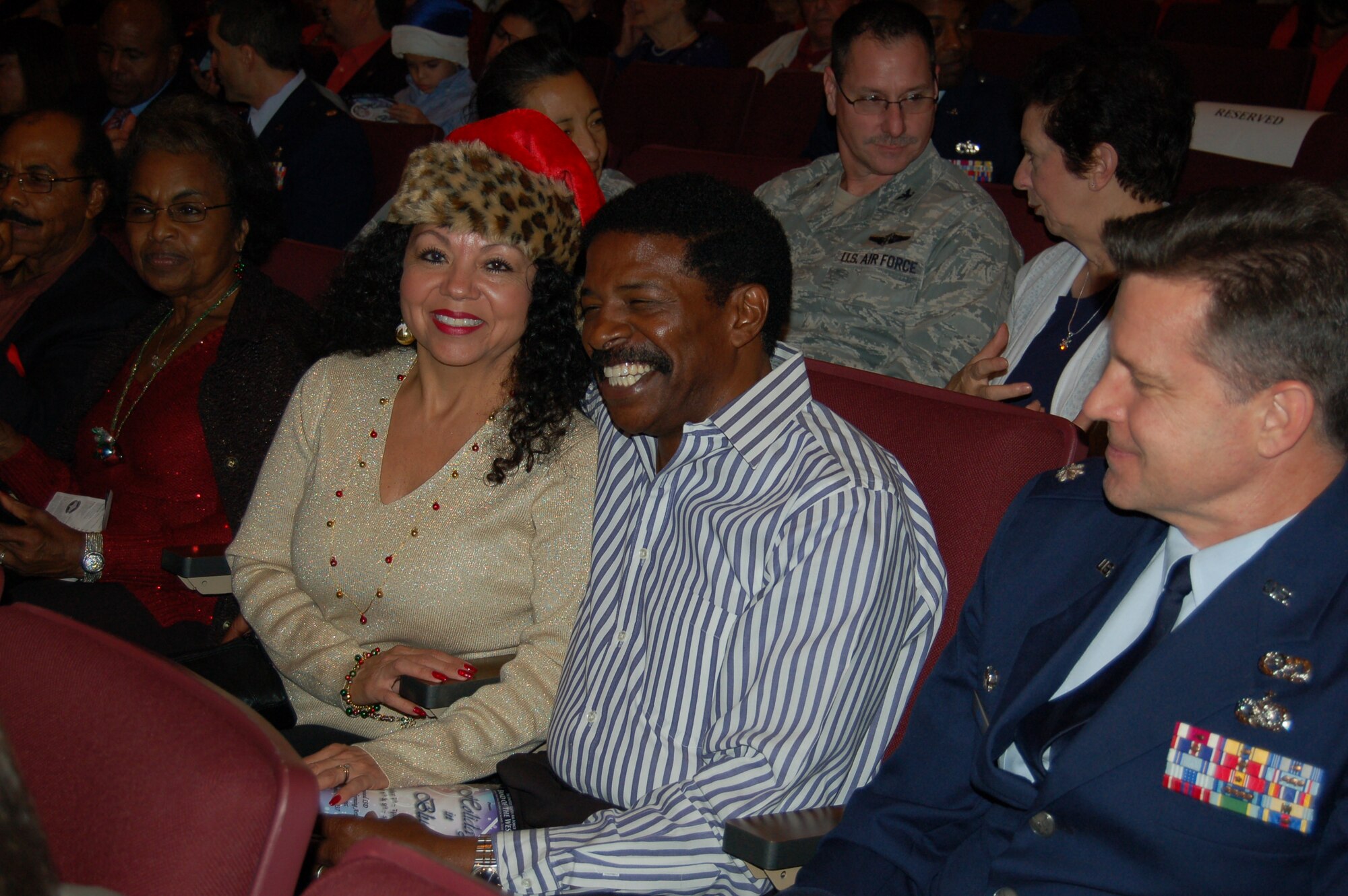Lt. Col. Michael Webb, commander of the 433rd Aircraft Maintenance Squadron, joins his Honorary Commander, Otis Scott, and his wife, Rosalinda, at the annual Holiday in Blue concert, held Dec. 9, at the Edgewood Theater for the Performing Arts in San Antonio, Texas.  Sponsored by the U.S. Air Force Band of the West, the concert is a staple in the local holiday entertainment schedule.  The Honorary Commanders program, sponsored by 433rd AW commander, Col. Jeffrey T. Pennington, partners wing leadership with local and area civic and business leaders to cultivate and educate them about the wing's mission in the Air Force Reserve, the U.S. Air Force, and the national defense.