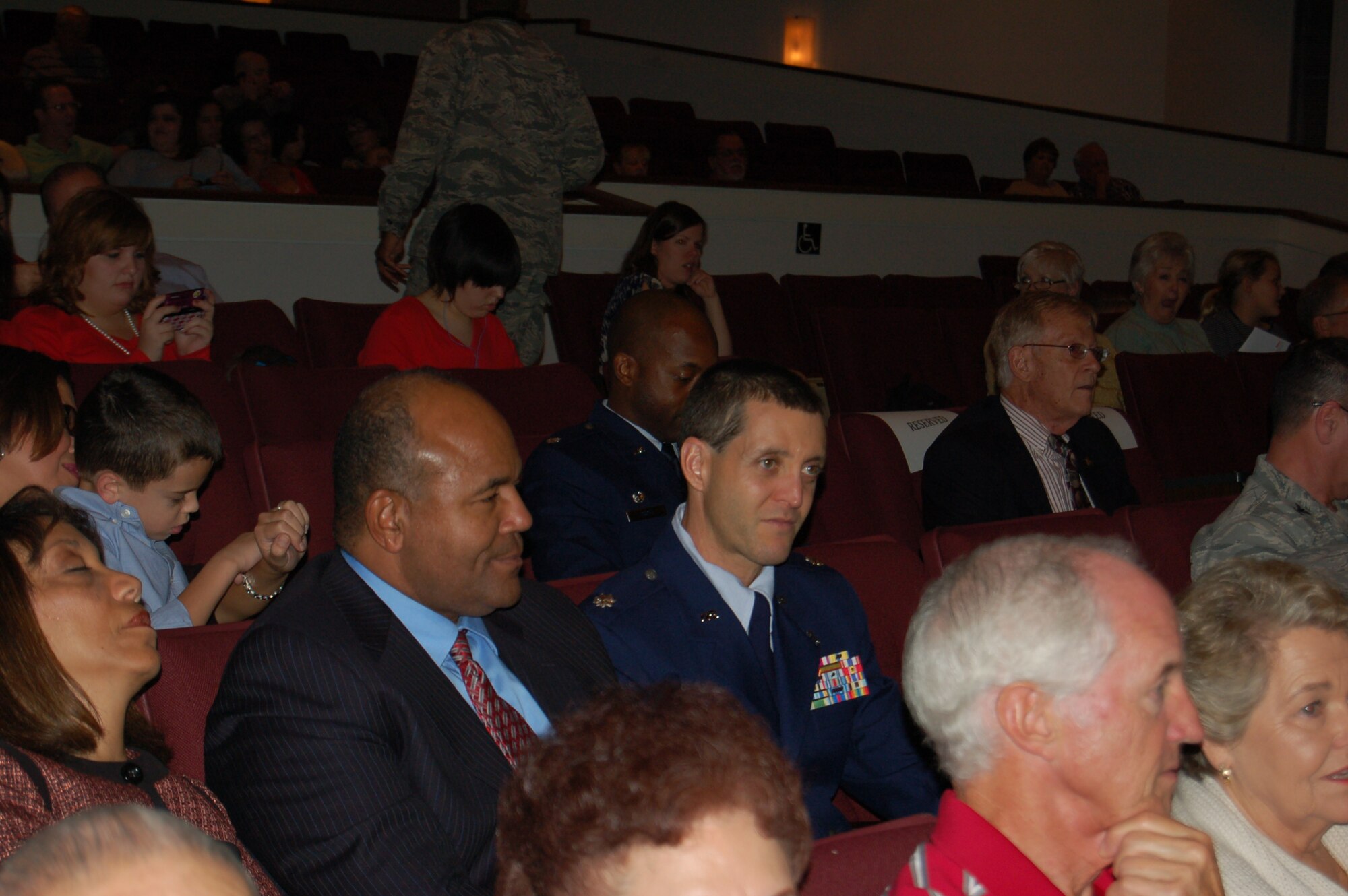 Lt. Col. Mark Goldstein, deputy commander of the 433rd Aeromedical Staging Squadron, joins his squadron's Honorary Commander, Odis Blueitt, and his wife, Pauletta, at the annual Holiday in Blue concert, held Dec. 9 at the Edgewood Theater for the Performing Arts in San Antonio, Texas.  Sponsored by the U.S. Air Force Band of the West, the concert is a staple of the local holiday entertainment schedule. The wing's Honorary Commanders program partners wing leadership with local and area civic and business leaders to inform them about the wing's missions and roles in the Air Force Reserve, the U.S. Air Force and the national defense.