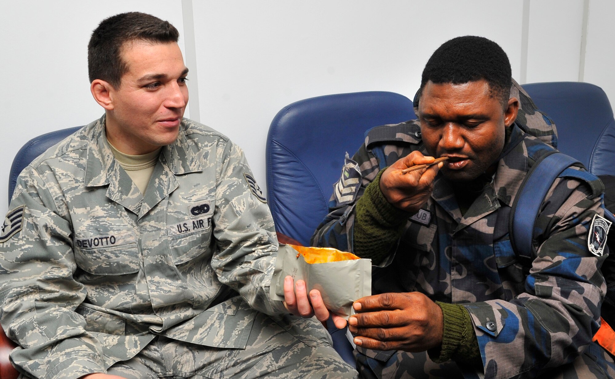 Staff Sgt. Luis Devotto, 435th Contingency Response Group, shares a meal ready-to-eat with Nigerian Air Force Flight Sgt. Yusuf B. Umar after demonstrating how to prepare the meal, Dec. 6, 2012, at Ramstein Air Base, Germany. Five members of the Nigerian air force quick response force visited CRG to gain a better understanding of their construct, capabilities, and employment. With these partnerships, the United States is able to teach and learn new mission techniques from counterparts from other nations. (U.S. Air Force photo/Tech. Sgt. Tyrona Lawson)