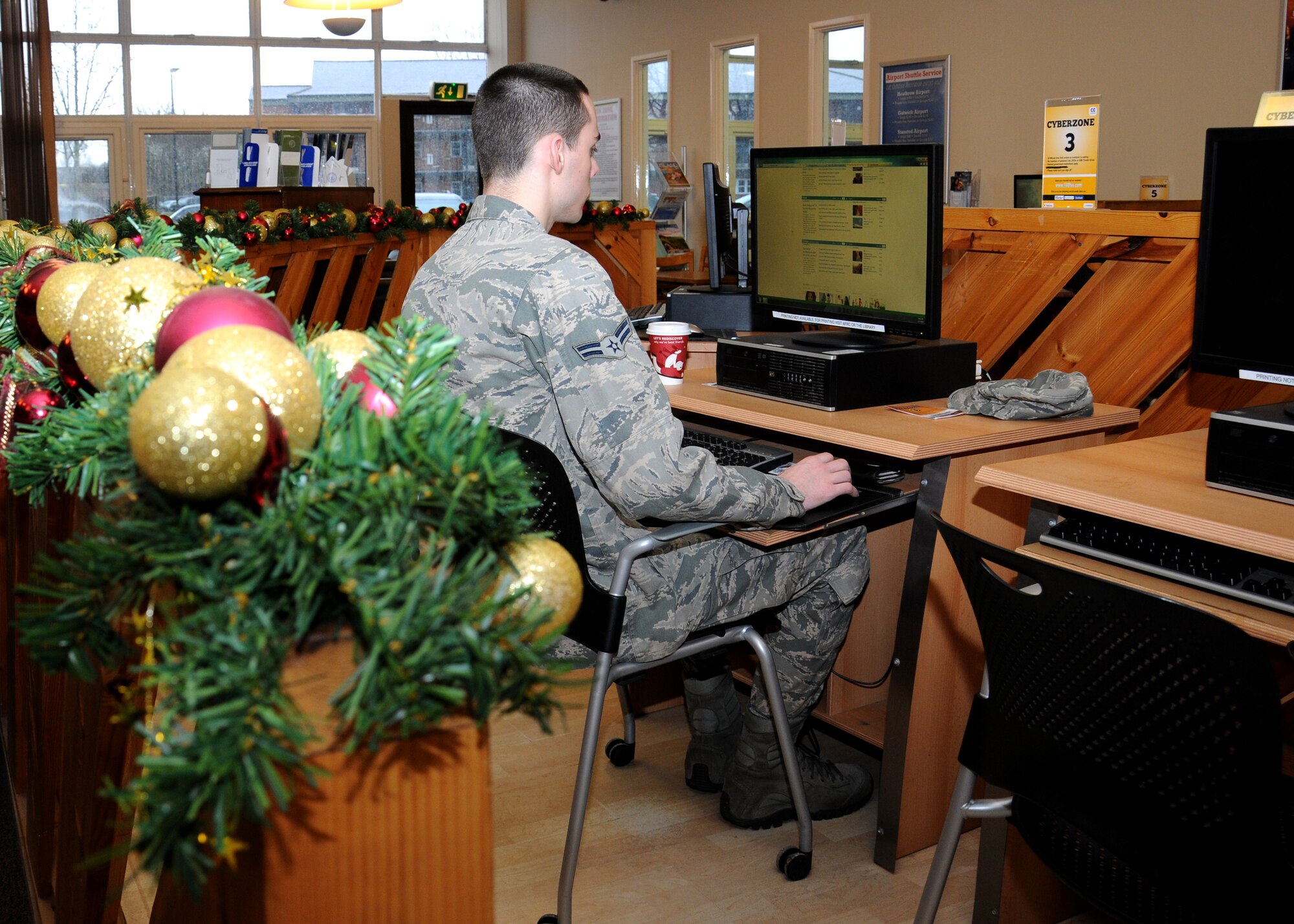 Airman 1st Class Joshua Kannegiesser, 100th Logistics Readiness Squadron hazardous materials journeyman from Brunswich, Md., utilizes the Bob Hope community center Cyberzone facilities Dec. 7, 2012, at RAF Mildenhall, England.  Other services and products located in the community center include a Funzone for children, local area maps, fax service, British stamps, cell phone top-ups, balloon sales, auto resale, music lessons, an amateur theater group and an Airmen’s lounge with computer games and pool tables. (U.S. Air Force photo by Gina Randall/Released)