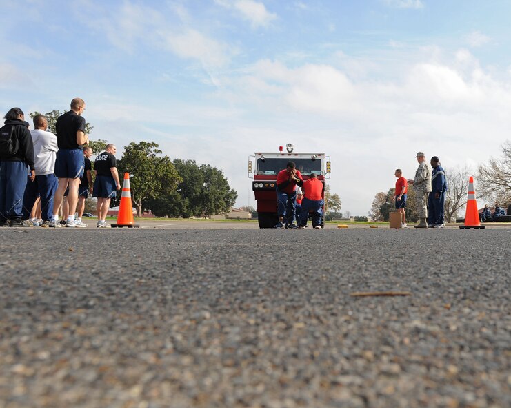 Airmen from the 2nd Force Support Squadron pull a fire truck during the 2nd Mission Support Group Olympics on Barksdale Air Force Base, La., Dec. 7. With the driver, fire equipment and water in the fire truck, the total weight pulled was more than 34,000 pounds. The fire truck must be fully equipped at all times in case of emergencies. (U.S. Air Force photo/Senior Airman Micaiah Anthony) 