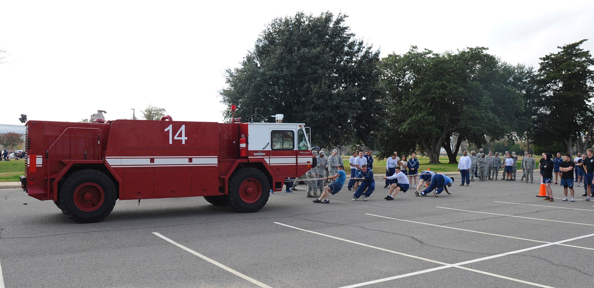 Airmen from the 2nd Civil Engineer Squadron pull a fire truck during the 2nd Mission Support Group Olympics on Barksdale Air Force Base, La., Dec. 7. With the driver, fire equipment and water in the fire truck, the total weight pulled was more than 34,000 pounds. The fire truck must be fully equipped at all times in case of emergencies. The 2 CES team placed second in the competition. (U.S. Air Force photo/Senior Airman Micaiah Anthony)