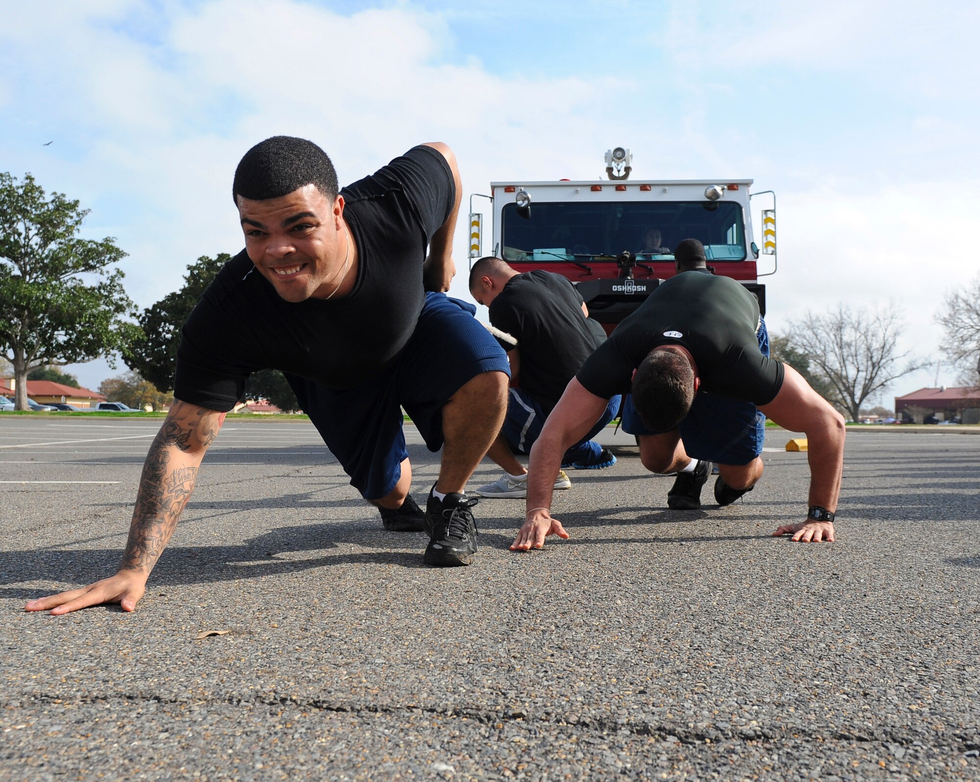 Airmen from the 2nd Security Forces Squadron, pull a fire truck during the 2nd Mission Support Group Olympics on Barksdale Air Force Base, La., Dec. 7. The 2 SFS submitted two teams for the competition. Security Forces team two won the fire truck pull competition. (U.S. Air Force photo/Senior Airman Micaiah Anthony)