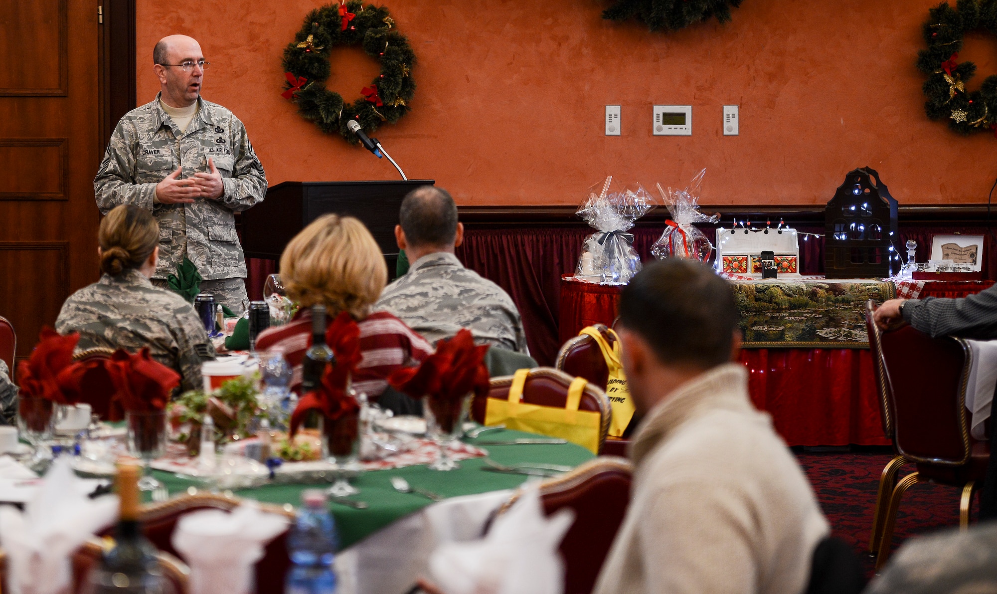 Chief Master Sgt. Jeffrey Craver, 31st Fighter Wing command chief, speaks during an Americans Working Around the Globe conference Dec. 6 at Aviano Air Base, Italy. More than 115 people attended the conference by the non-profit private organization. Attendees heard from 13 expert speakers who covered topics geared toward improving volunteer leadership, marketing, continuity, finances and more. (U.S. Air Force photo by Senior Airman Katherine Tereyama)