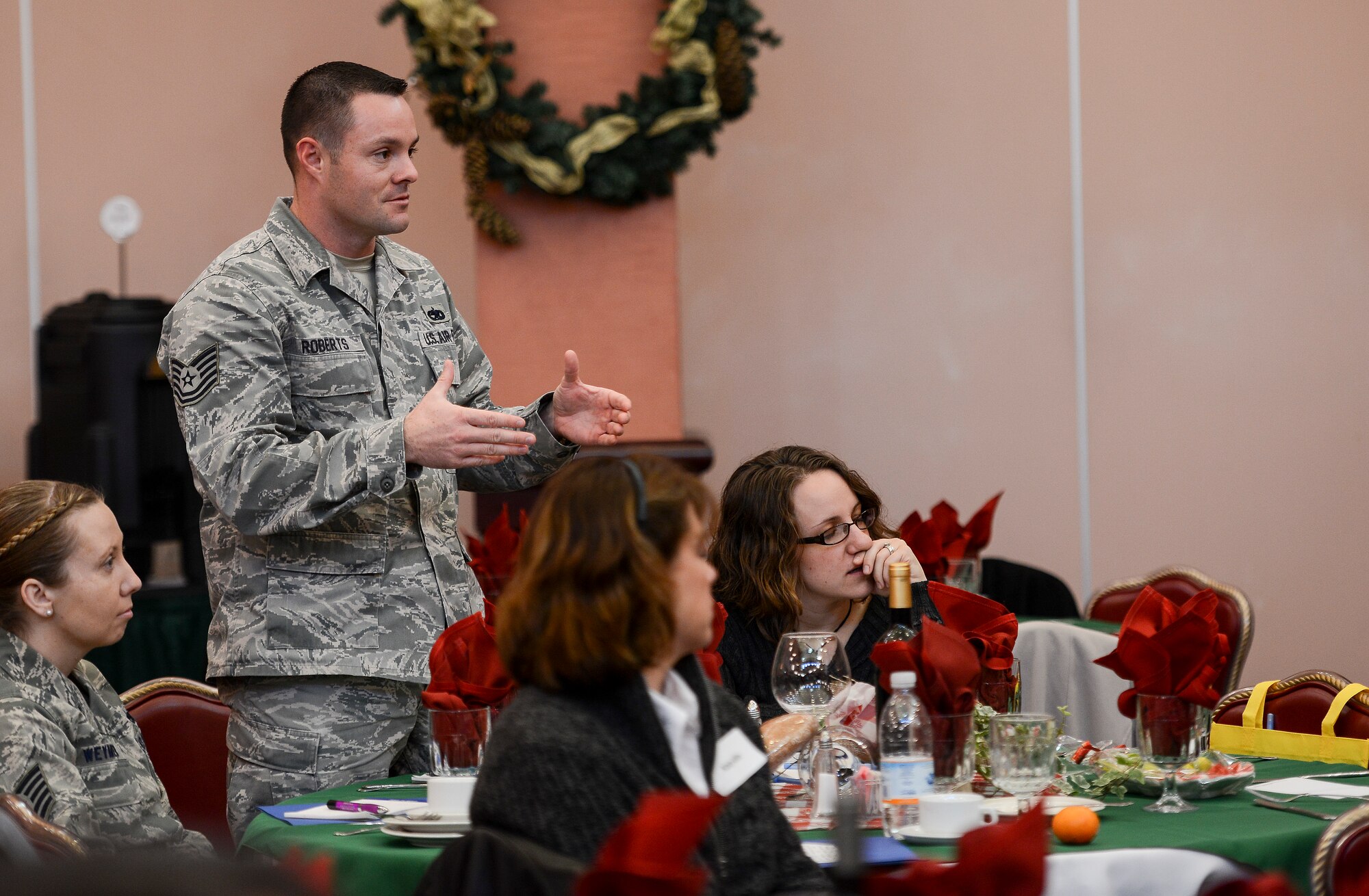 Tech. Sgt. Joshua Roberts, 31st Munitions Squadron storage plans NCO in charge, asks  a question during an Americans Working Around the Globe conference Dec. 6 at Aviano Air Base, Italy. More than 115 people attended the conference by the non-profit private organization. Representing military members and civilians working overseas, AWAG offers leadership development training, facilitates volunteerism and fosters relationships between Americans and their host-country nationals. (U.S. Air Force photo by Senior Airman Katherine Tereyama)