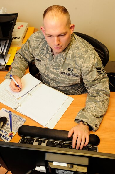 Staff Sgt. Andrew Mohr, 95th Reconnaissance Squadron aviation resource manager, updates aircrew flying training records Dec. 10, 2012, at RAF Mildenhall, England. (U.S. Air Force photo by Airman 1st Class Dillon Johnston/Released)