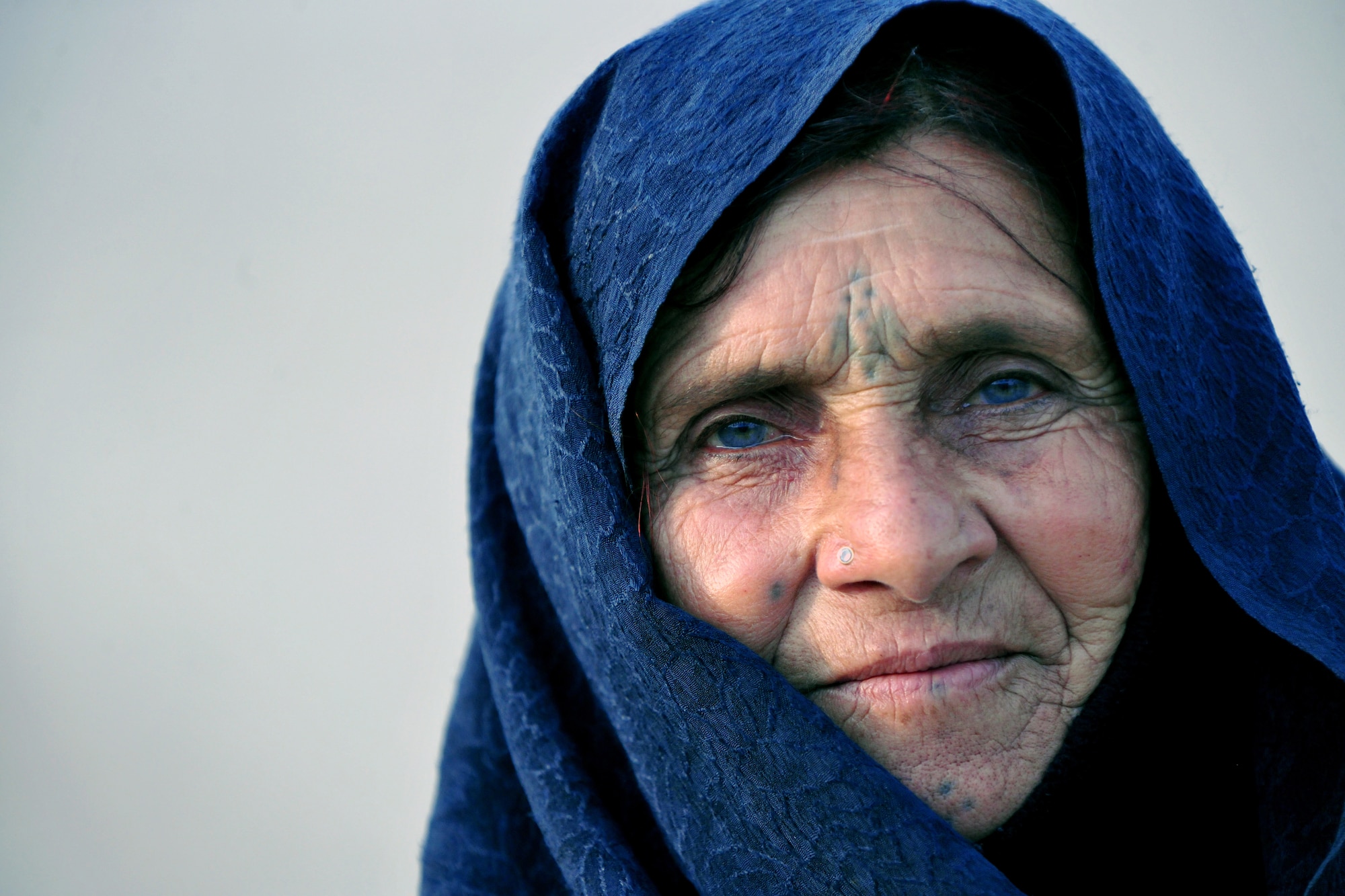 A local Afghan woman waits to process through the medical entry control point at Bagram Airfield, Afghanistan, Dec. 10, 2012.  Members of the 455th Expeditionary Security Forces Group bravo sector and Afghan local guards process as many as 400 people from outside the gate needing services ranging from basic clinical care to student vocational programs.  (U.S. Air Force photo/Senior Airman Chris Willis)