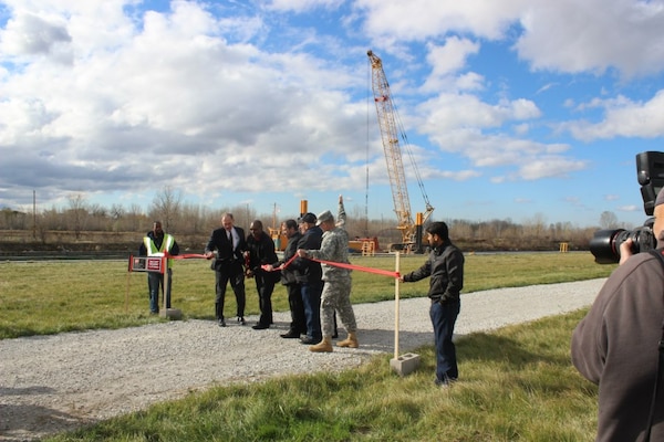 USACE Chicago District Commander Col. Frederic A. Drummond Jr. joins East Chicago Mayor Anthony Copeland as he cuts ribbon alongside Rep. Pete Visclosky (IN-1) (at left) to mark completion for the Indiana Harbor and Canal Confined Disposal Facility and start of dredging, East Chicago, Ind., Oct. 29, 2012.