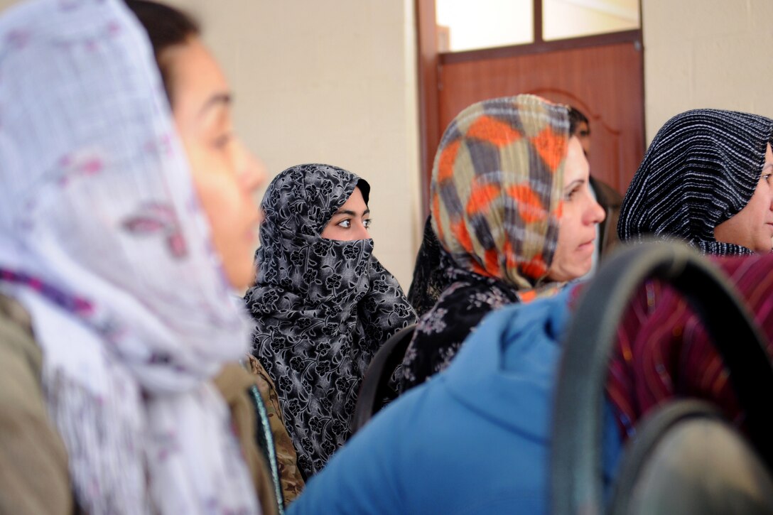 A young Afghan woman looks on during a women's meeting in Farah, Afghanistan, Dec. 6, 2012.