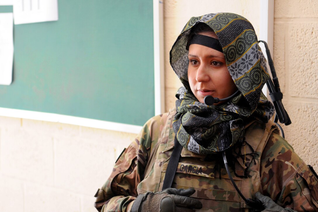 U.S. Navy Petty Officer 1st Class Megan Garcia provides security outside a women's shura in Farah, Afghanistan, Dec. 6, 2012. Garcia, a operations specialist tactical watchstander, is assigned to Provincial Reconstruction Team Farah.