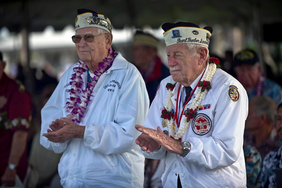 Edgar Harrison and Delton Walling, Pearl Harbor survivors, applaud during a Dec. 7, 2012, remembrance ceremony marking the 71st anniversary of the attack on Pearl Harbor and the island of Oahu, at the World War II Valor in the Pacific National Monument in Honolulu.