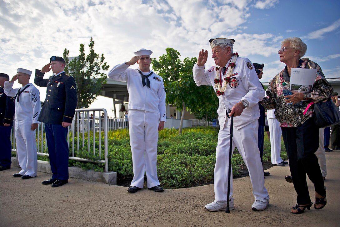 Delton Walling, a Pearl Harbor survivor, salutes as he walks through an honor cordon during a Dec. 7, 2012, remembrance ceremony marking the 71st anniversary of the attack on Pearl Harbor and the island of Oahu, at the World War II Valor in the Pacific National Monument in Honolulu.