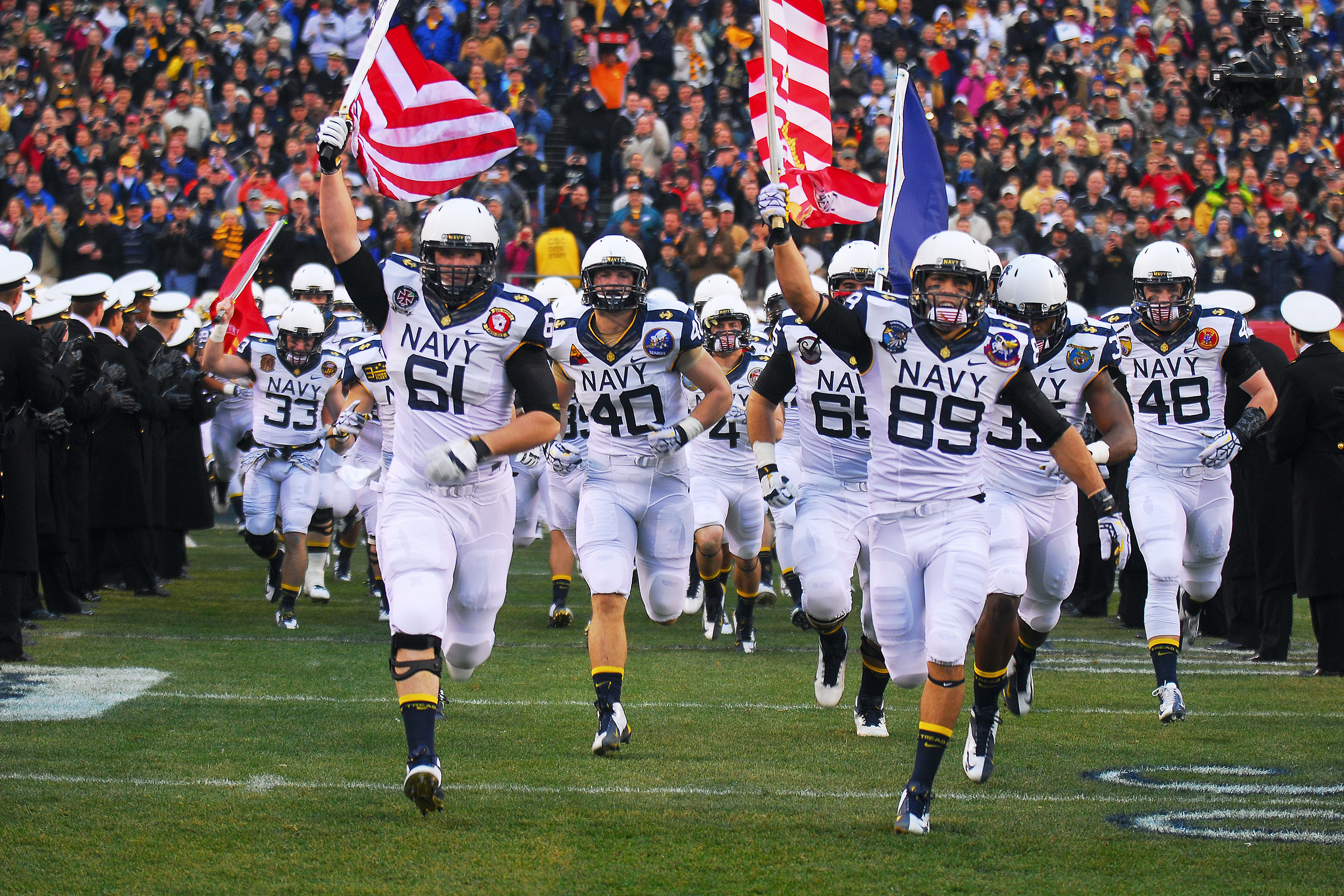 U.S. Naval Academy midshipmen take the football field for the Army