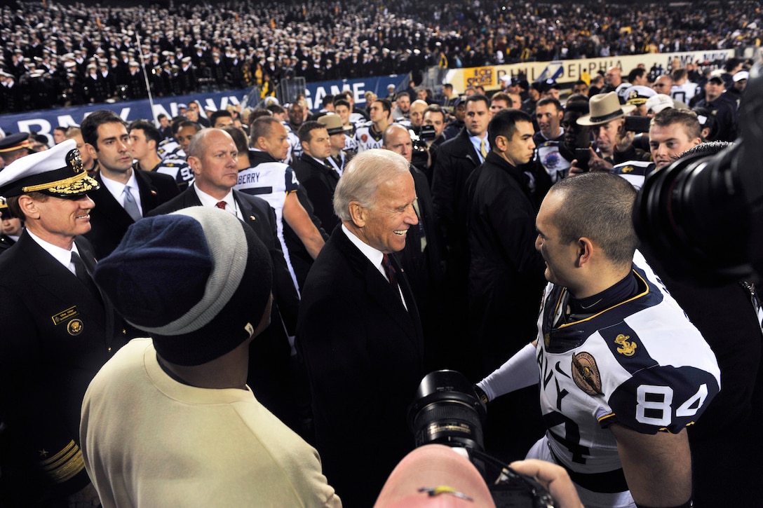 Vice President Joe Biden congratulates Navy football players on the field after Navy beat Army 17 -13 at Lincoln Financial Field in Philadelphia, Dec. 8, 2012.