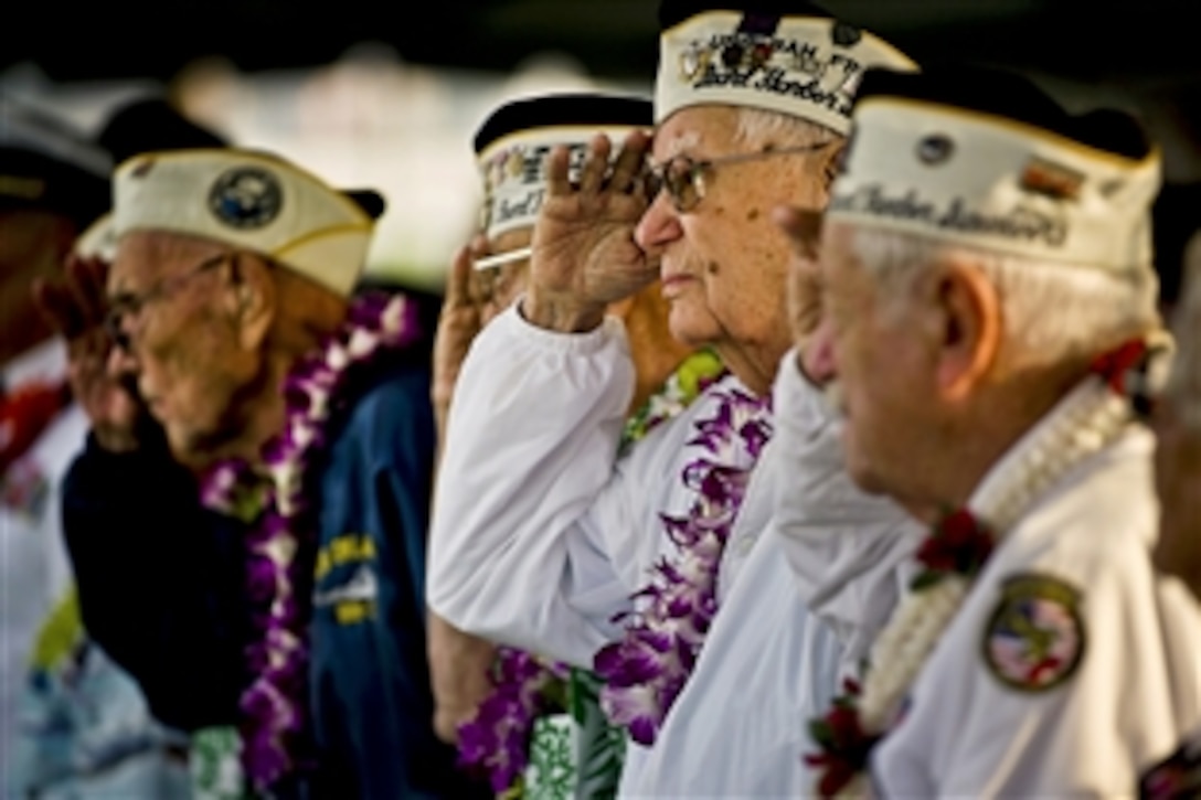Edgar Harrison, center, a Pearl Harbor survivor and World War II veteran, salutes as the national anthem is played during a remembrance ceremony marking the 71st anniversary of the Japanese attack on Pearl Harbor and Oahu, Hawaii, at the World War II Valor in the Pacific National Monument, formerly known as the USS Arizona Memorial Visitor Center, in Honolulu, Dec. 7, 2012. The attack lasted 110 minutes,  leaving 2,335 U.S. service members dead and 1,142 wounded. 