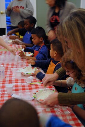 Children make homemade play dough during the Kids in the Kitchen on Monday at the McHugh Woods Community Center. The Exceptional Family Member Program and Families Over Coming Under Stress joined together to show the children how to talk about their feelings and make play dough.
