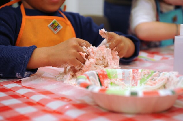 Alex, 5, molds his play dough during the Kids in the Kitchen on Monday at the McHugh Woods Community Center. The Exceptional Family Member Program and Families Over Coming Under Stress combined their efforts to teach the children how to make homemade play dough.