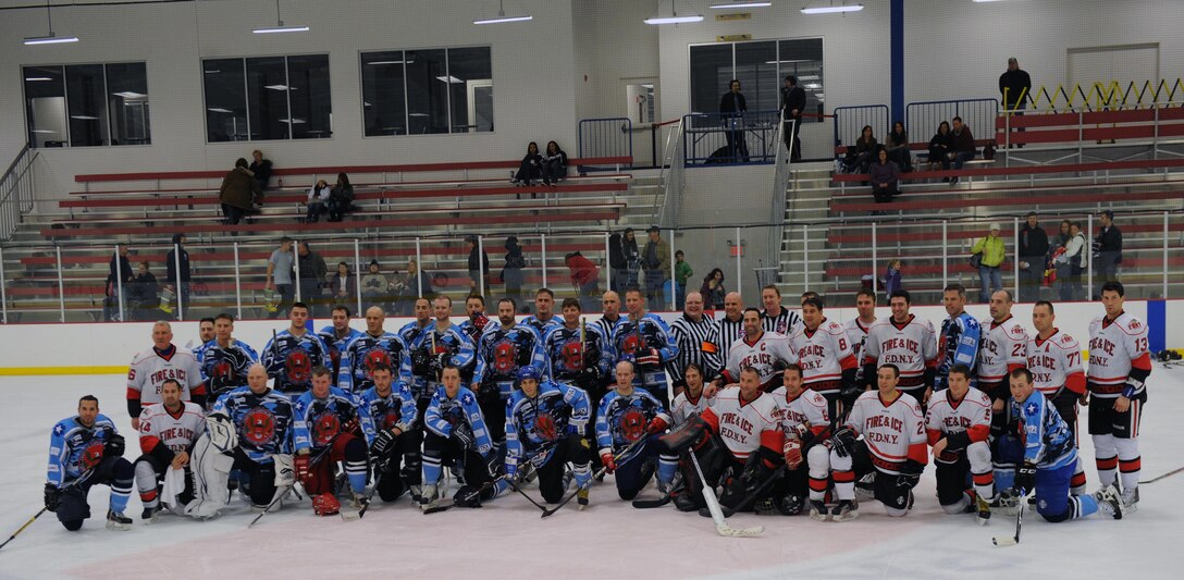 The National Capital Region Military Hockey Team and the New York City Fire Department Hockey Team pose for a picture after the 5th annual Toys for Tots Hockey Classic on Saturday at the Prince William Ice Center. 