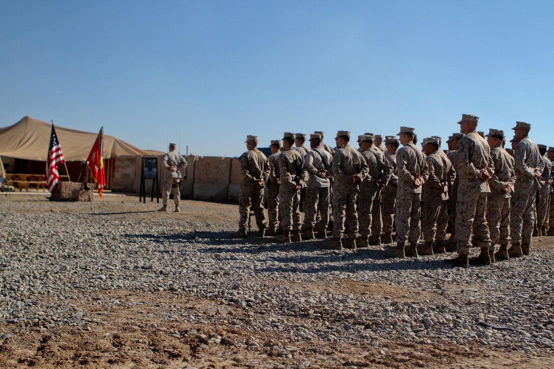 Marines and sailors with India Company, 3rd Battalion, 9th Marine Regiment, Regimental Combat Team 7, stand silently at parade rest during the beginning of a memorial service in honor of Lance Cpl. Anthony Denier, Dec. 8, 2012. Denier, a rifleman with the battalion, died while conducting combat operations in Marjah, Afghanistan, Dec. 2, 2012.