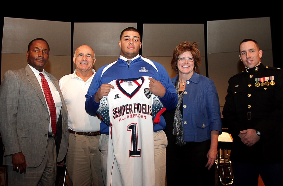 Rockhurst High School senior offensive tackle Zach Hannon was presented a jersey and formally selected to attend the second annual Semper Fidelis All-American Bowl game by Capt. Landon Dunaway, the operations officer of Recruiting Station Kansas City, at the Memorial Hall in the National World War I Museum, Dec. 11. Hannon is ranked 19th best offensive guard in the U.S. by www.Rivals.com.